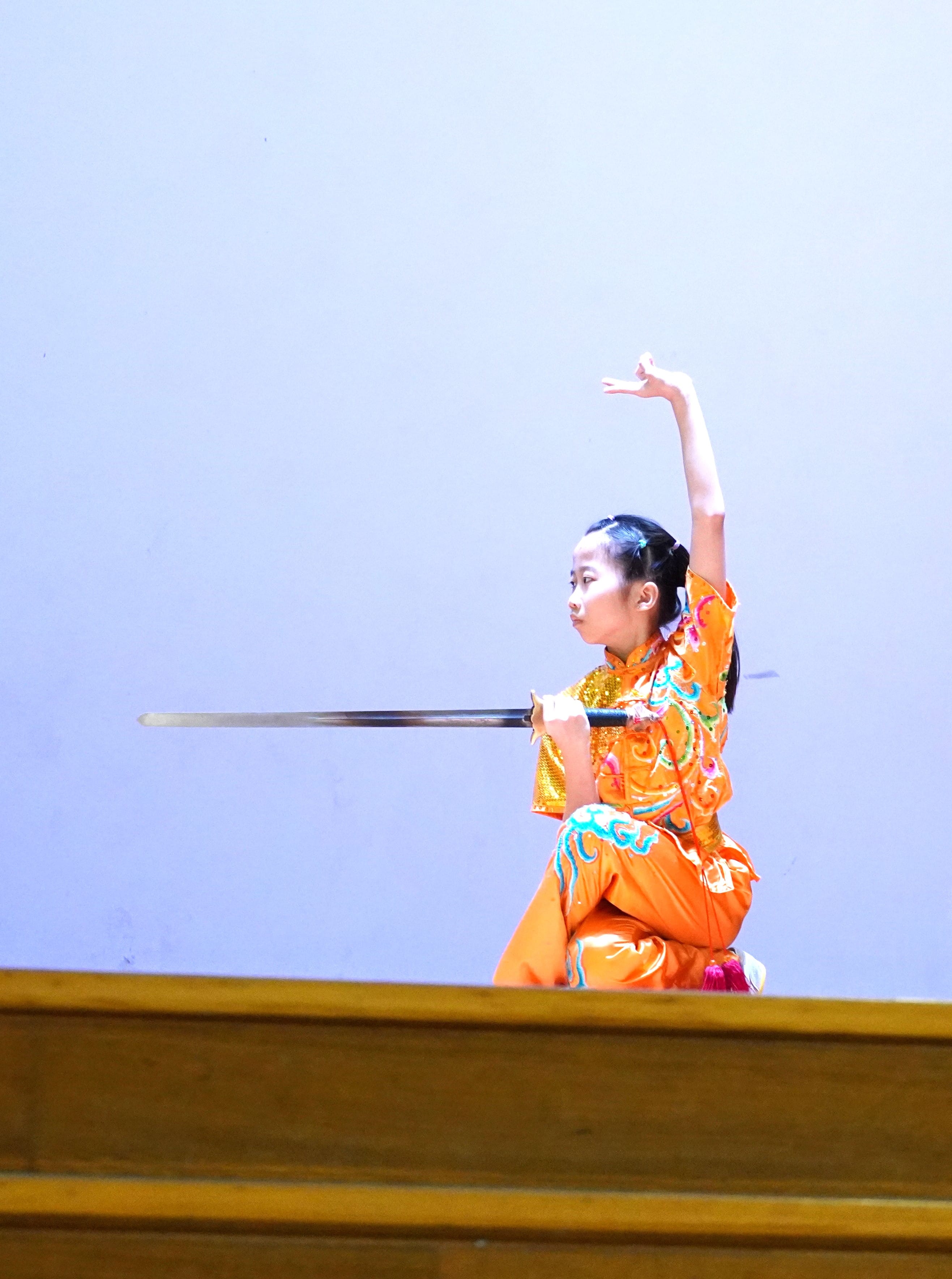 Student performing a traditional Chinese dance with a long prop.