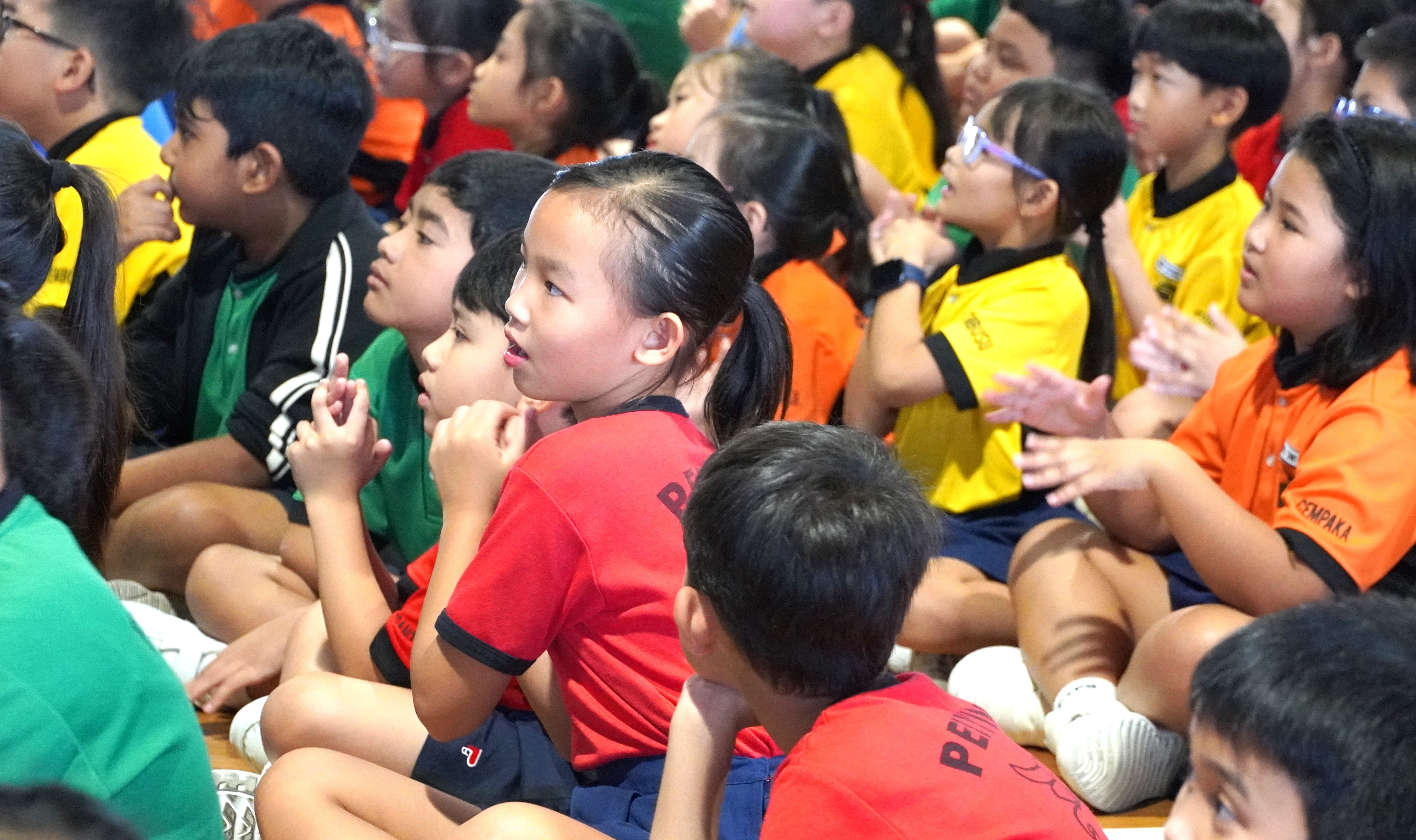 Students participating in a cultural activity with their peers.