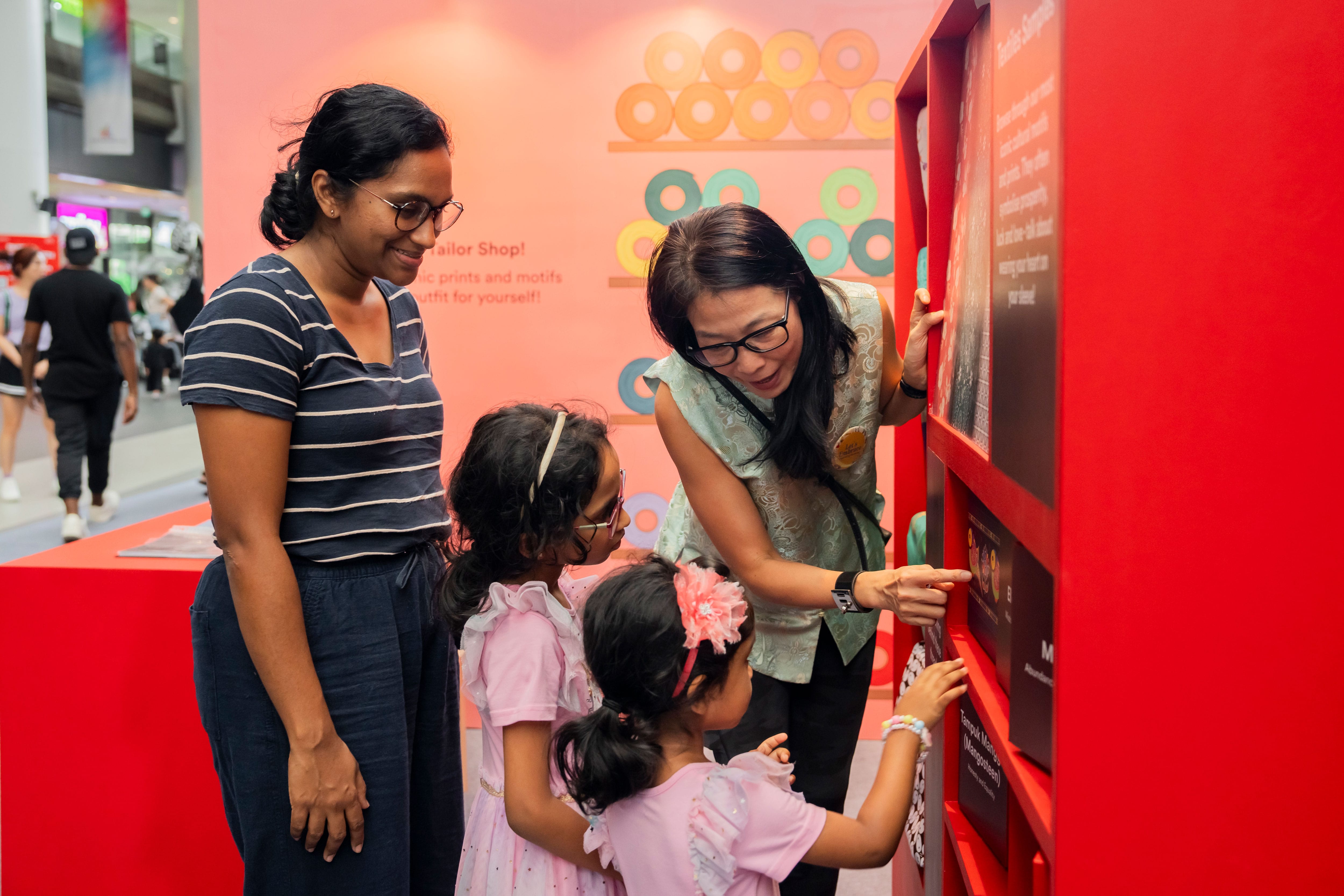 Woman showing kids an exhibition
