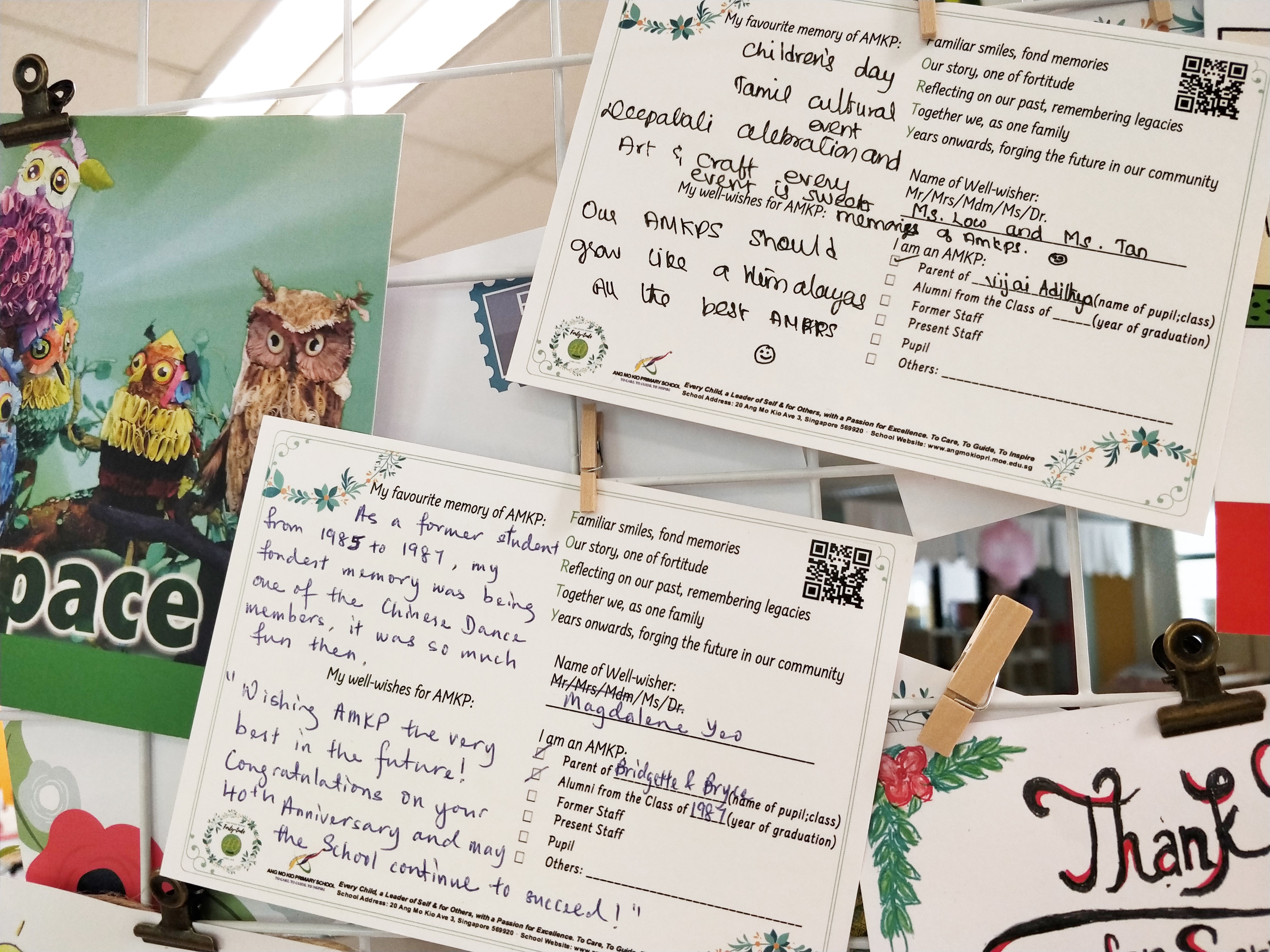 Handwritten memory and well-wish cards for AMKP school's 40th anniversary pinned on a display board.