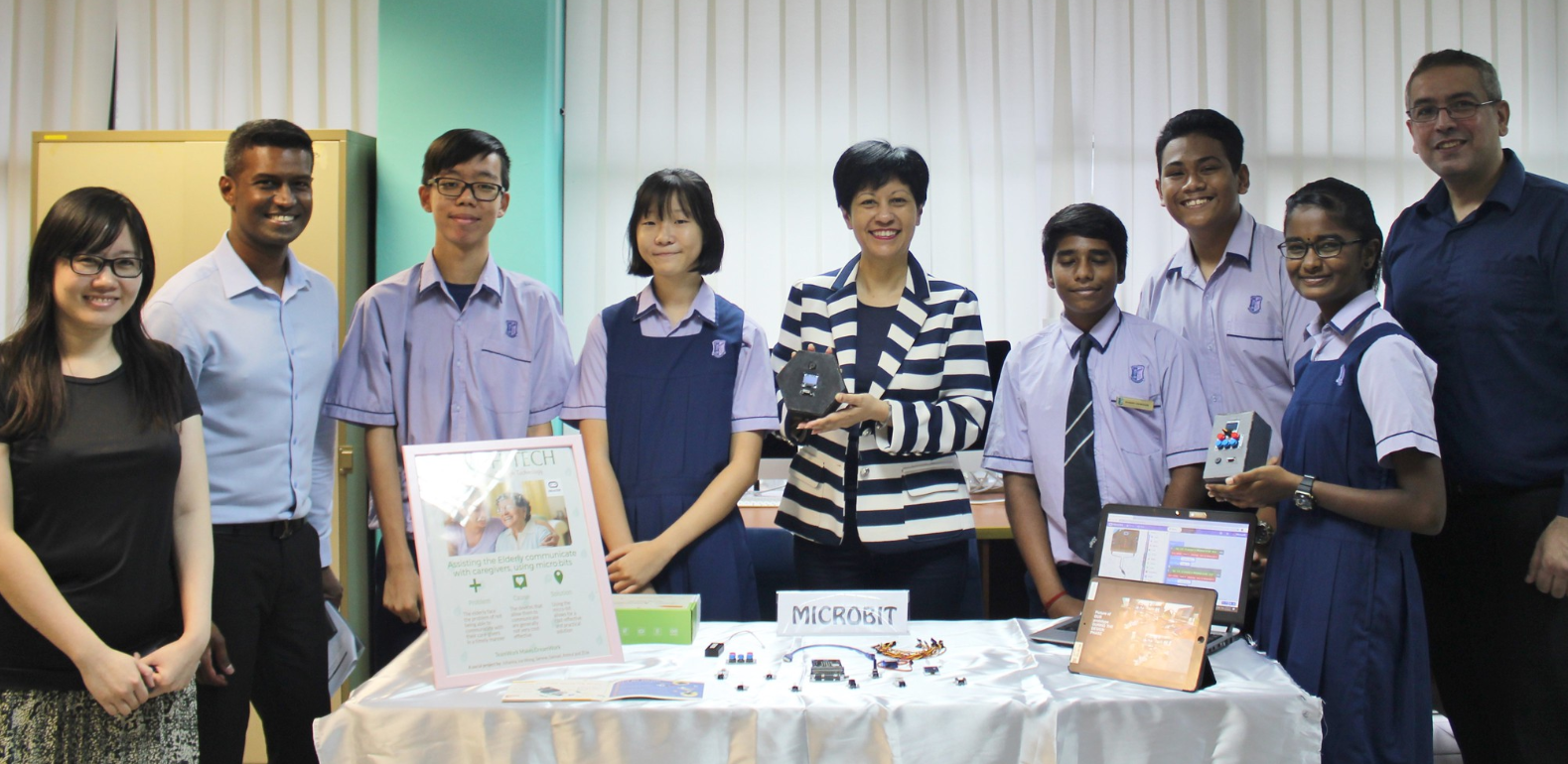 Ms Indranee and the team posing with the Micro:Bit that would enable timely elderly-caregiver communication. The device is developed in consideration of the needs and mindset of the elderly towards assistive technology and the multiple roles a caregiver plays.
