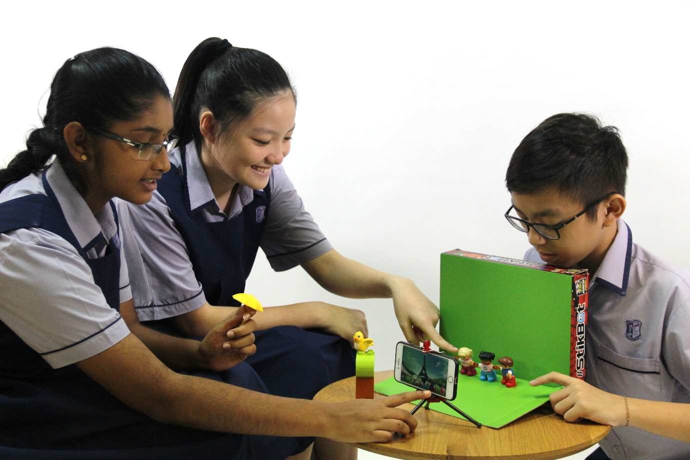 A group of Secondary 2 students demonstrating how a Stop-Motion Animation with Chroma Key effect is being produced 