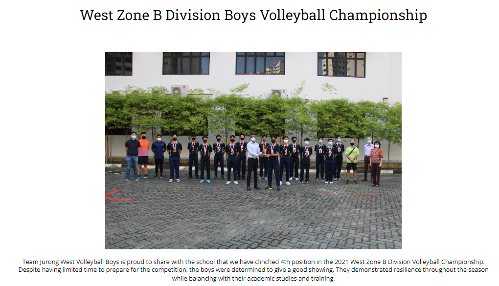 A group of boys volleyball team wearing medals posed outdoors in front of a building for a championship photo.