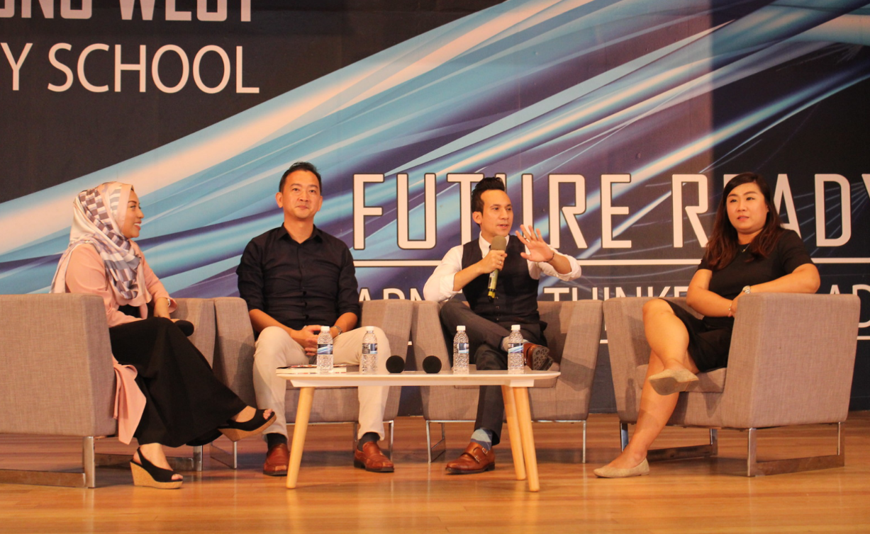 Four panelists seated on stage at a Future Ready school event, with one man speaking into a microphone.