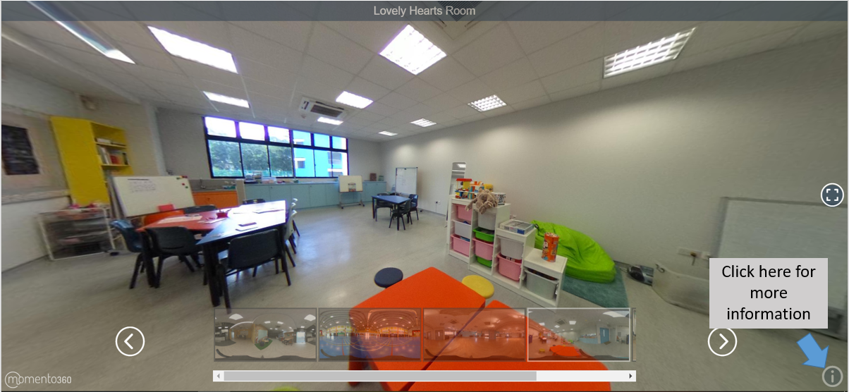360-degree view of a children's classroom with tables, chairs, colorful toy shelves, a whiteboard, and a green bean bag.