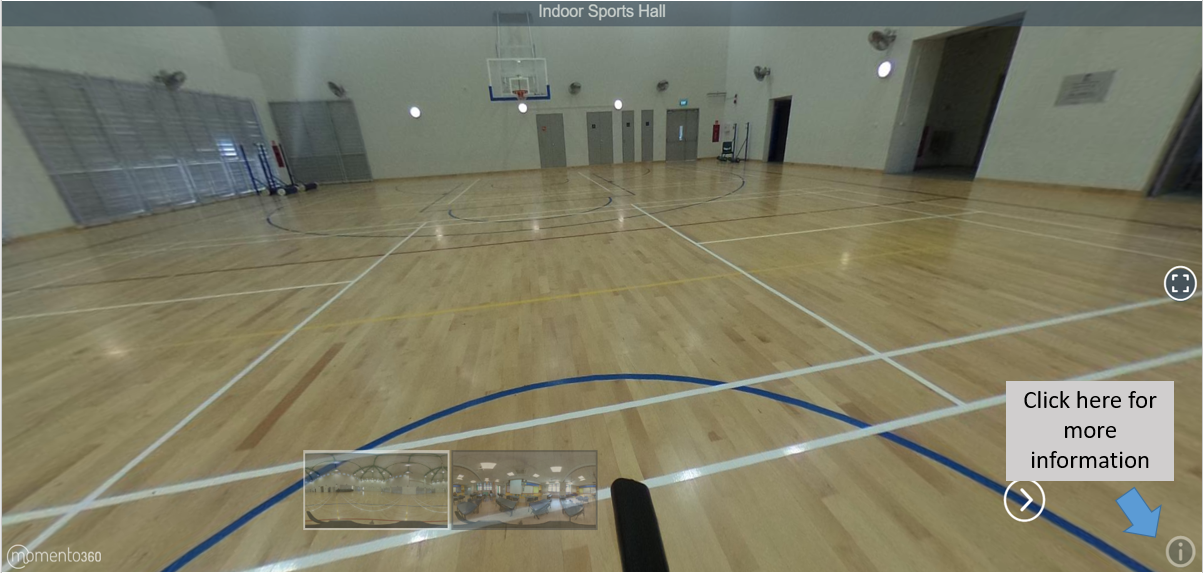 360-degree view of an empty indoor sports hall with a wooden court floor, painted lines, and a basketball hoop.