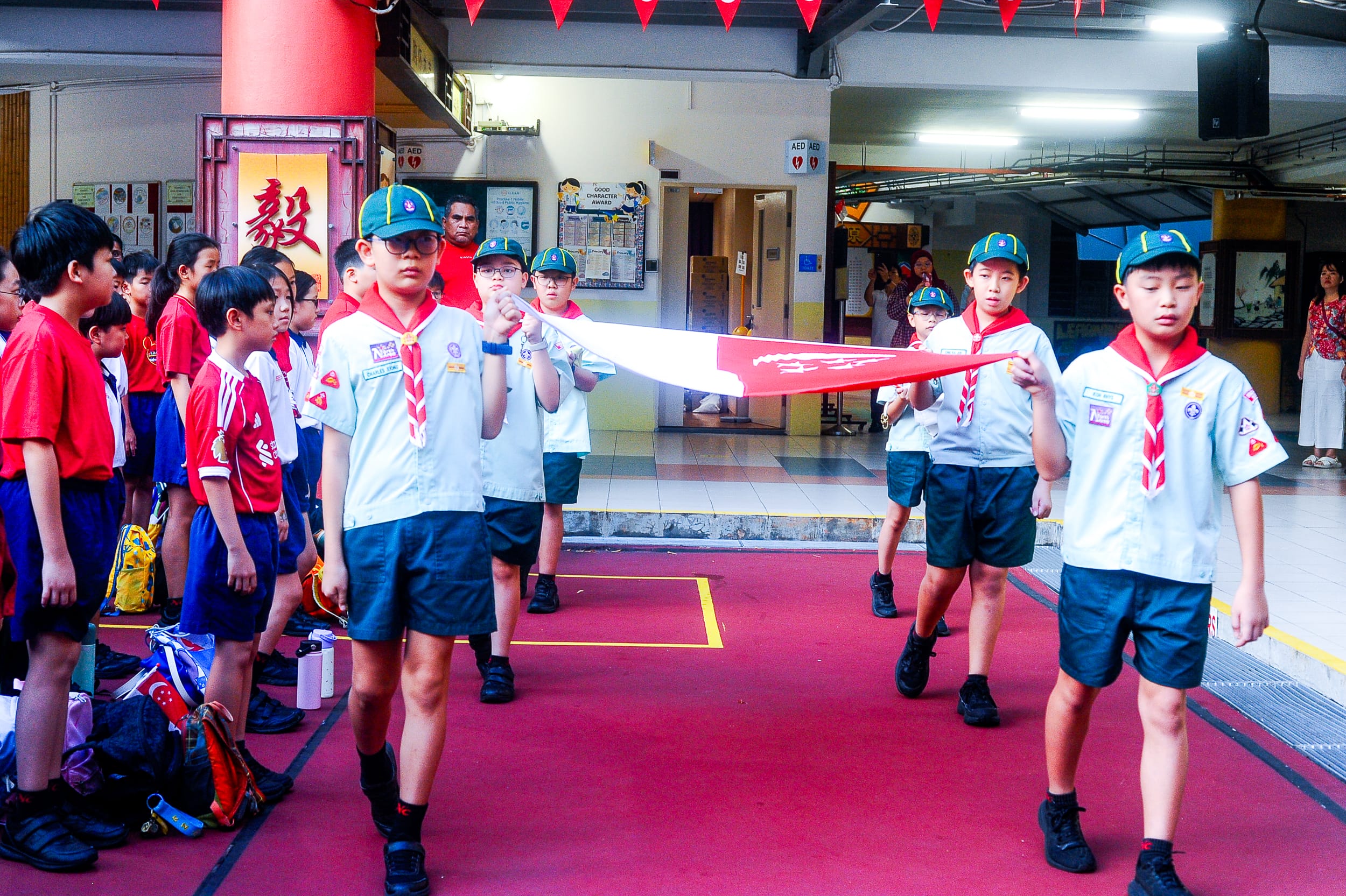 Students marching in with the national flag.