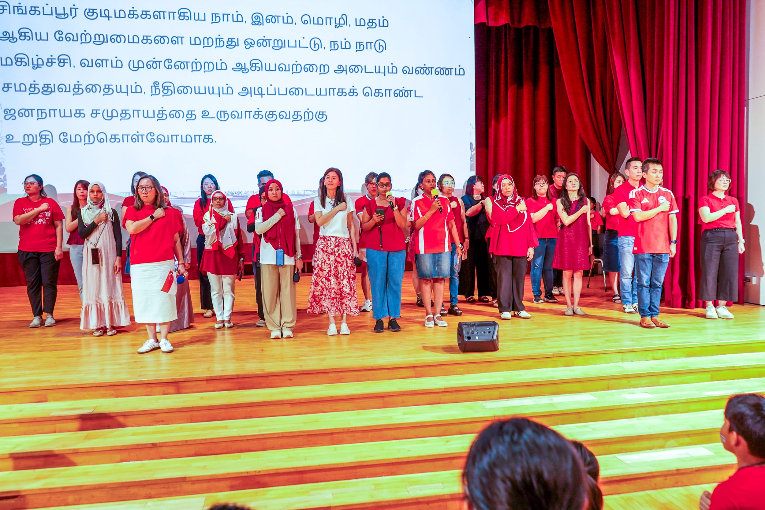 Mrs Ong leading the school in taking the pledge.
