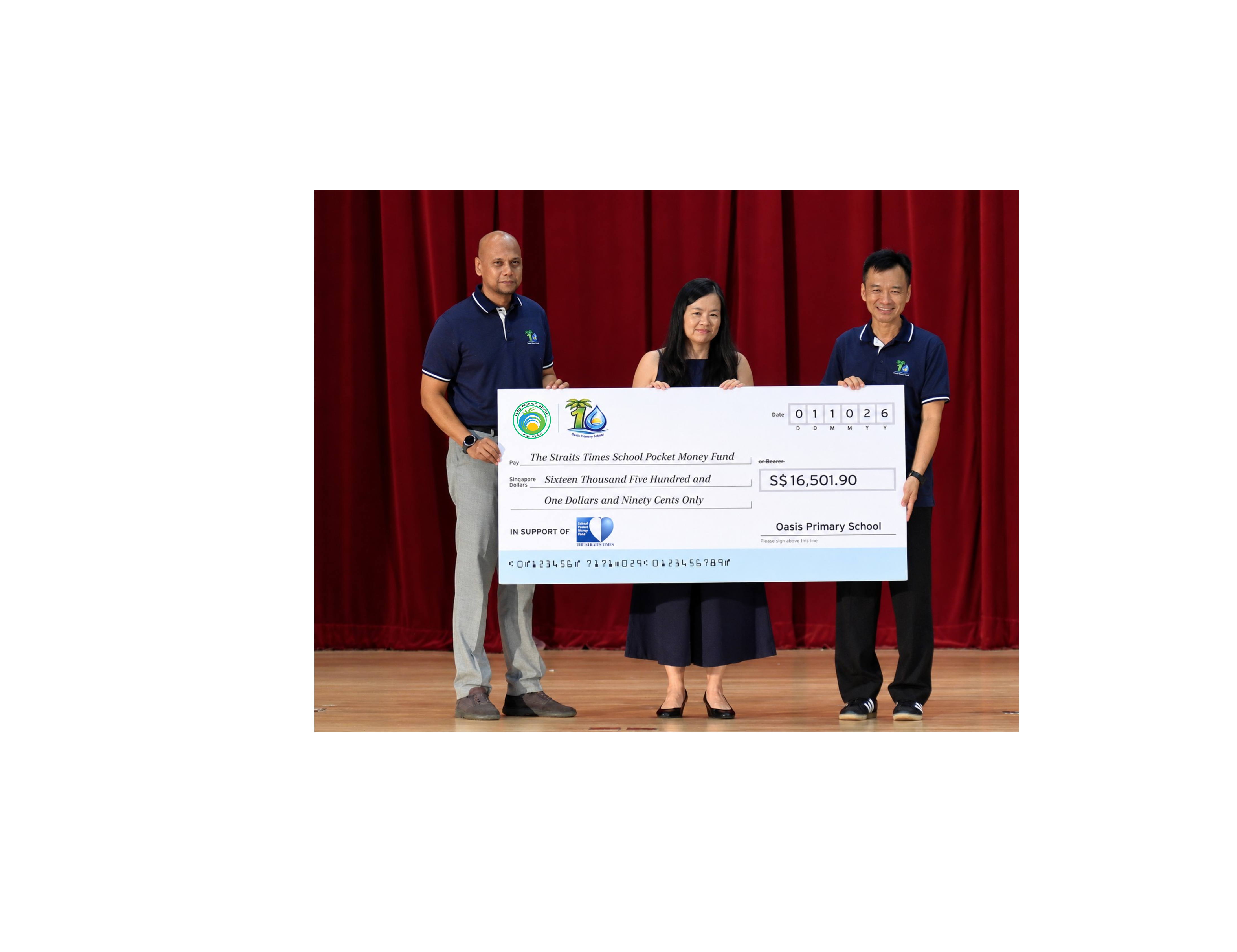 Three people hold a S$16,501.90 cheque for Oasis Primary School.
