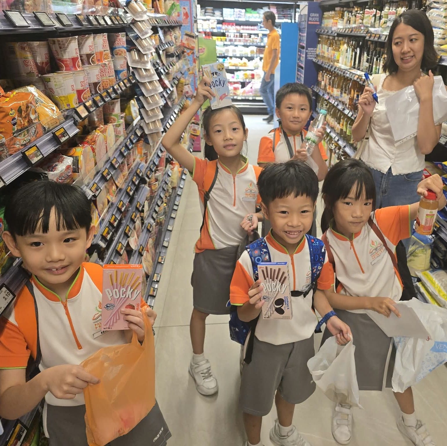 Happy students posing with their chosen snacks at the supermarket