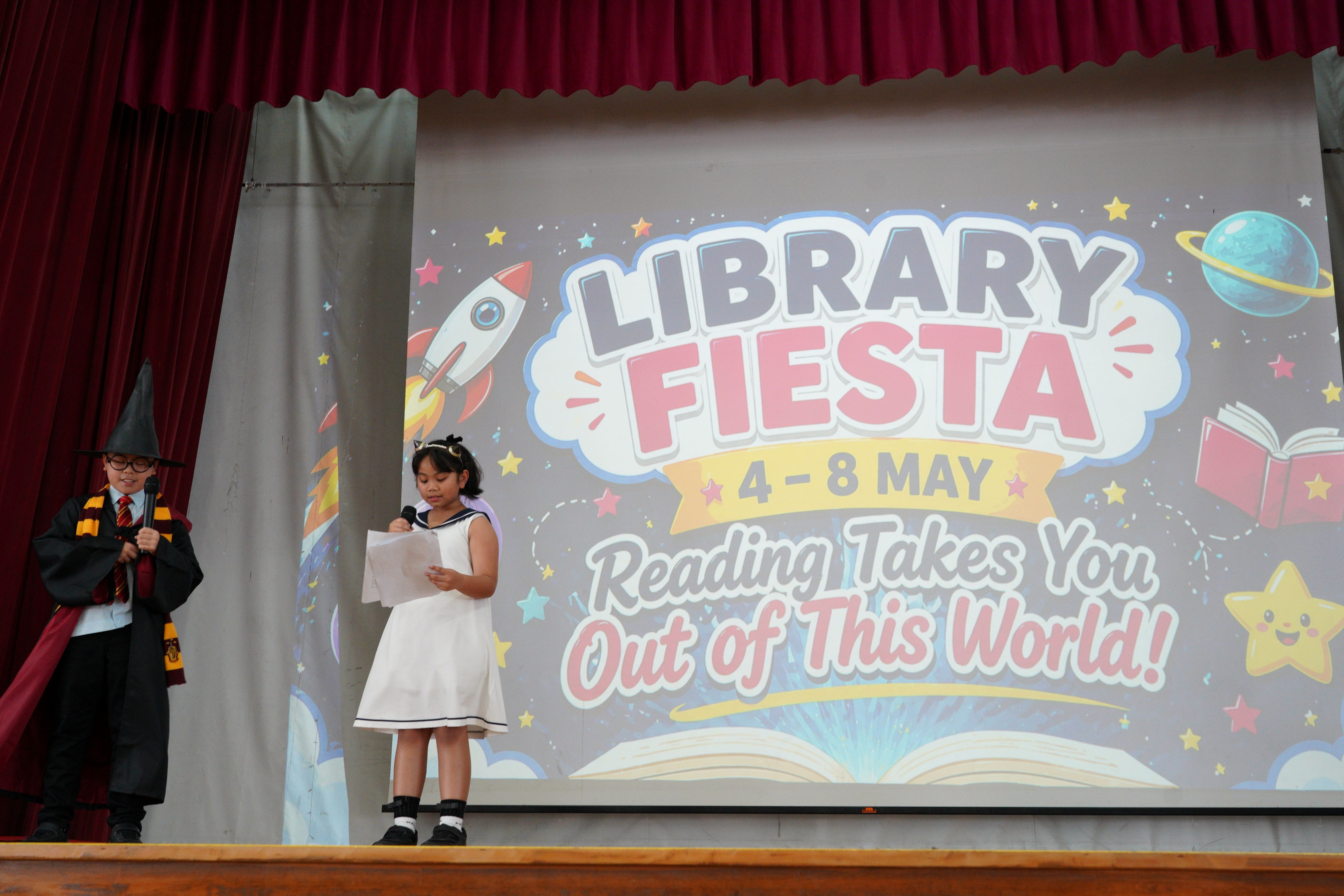 2 student emcees dressed up as their favourite characters on stage, during afternoon assembly
