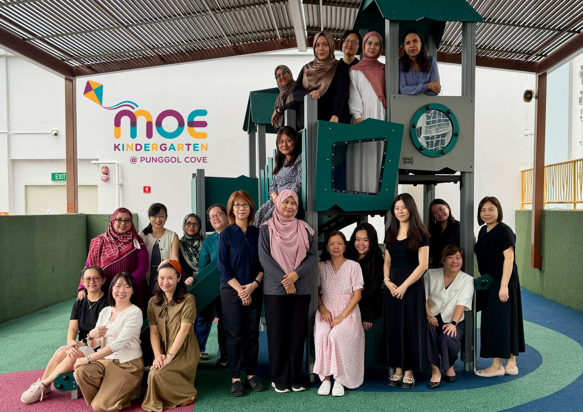 Group of women posing on and around a playground structure at MOE Kindergarten Punggol Cove.