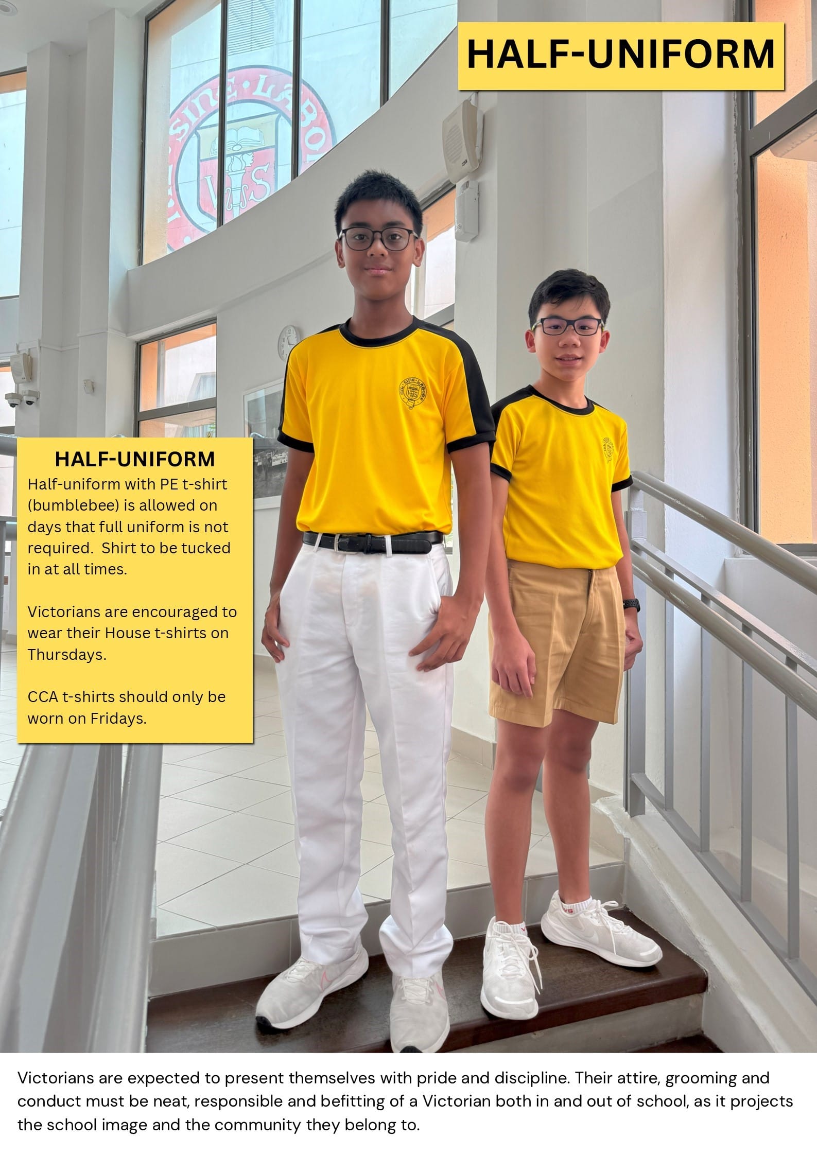 Two boys in yellow and black PE shirts stand on stairs, one in white pants and one in khaki shorts.