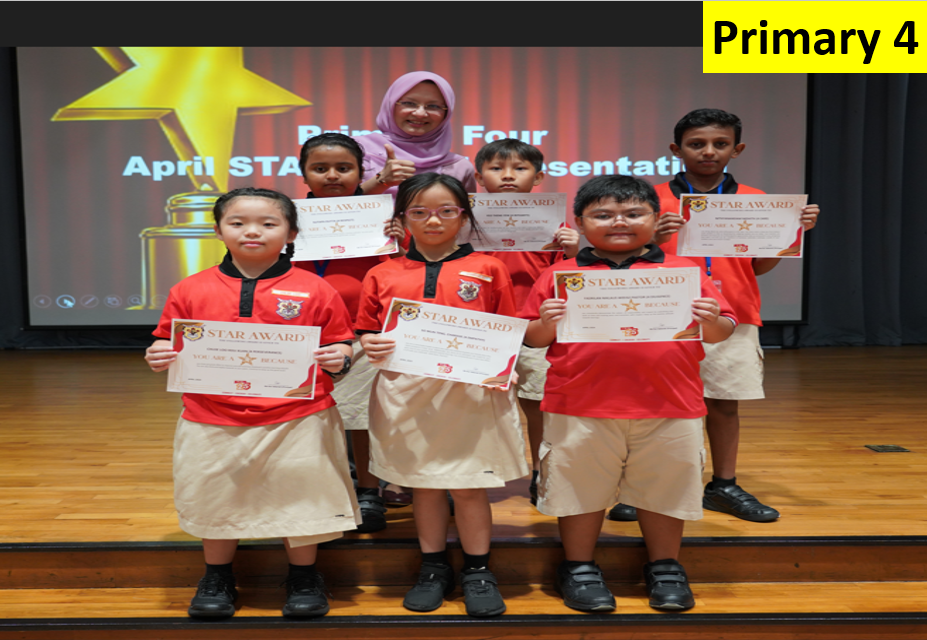 Six Primary 4 students in red uniforms hold Star Award certificates on stage with a teacher behind them.