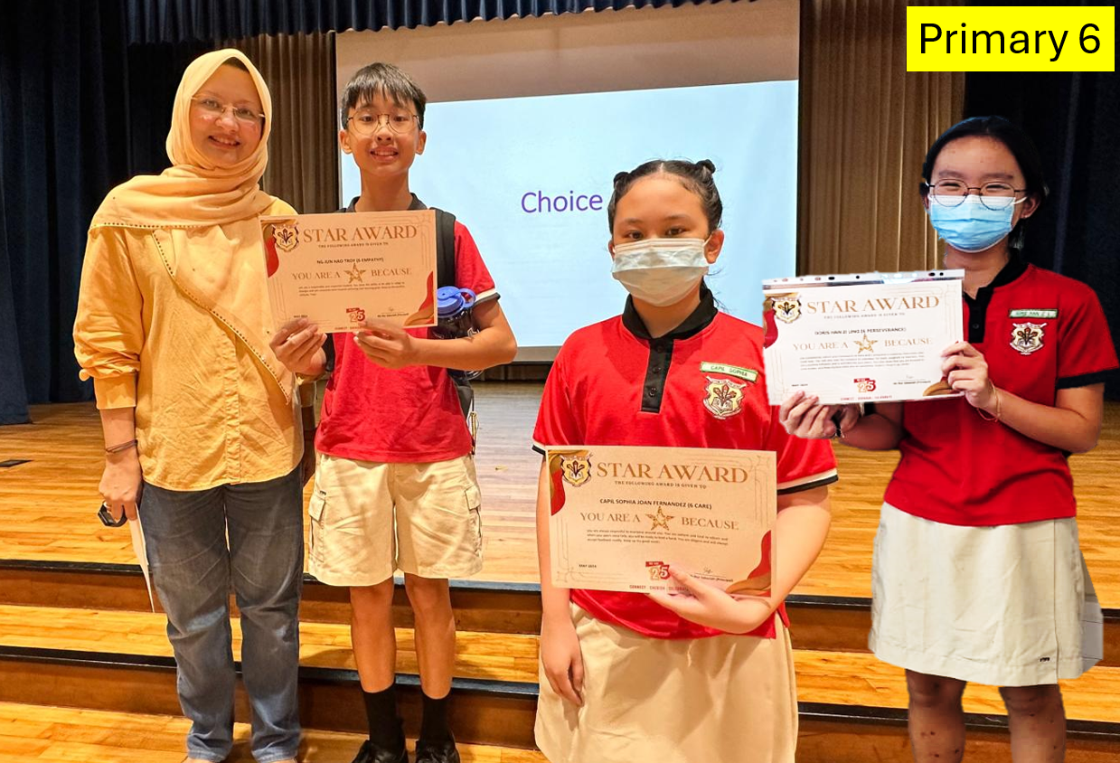 A teacher and three Primary 6 students pose holding Star Award certificates in a school hall.