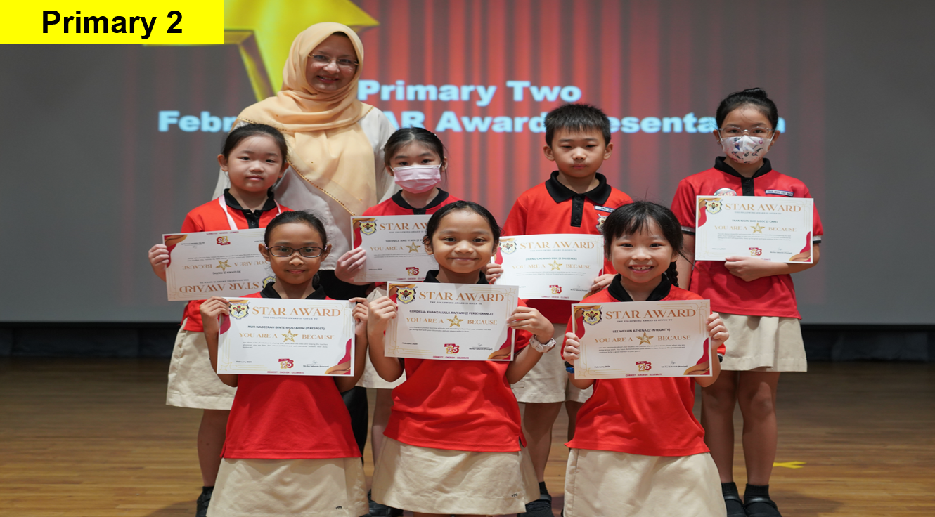 Seven Primary 2 students in red uniforms hold Star Award certificates, posing with a teacher on a stage.