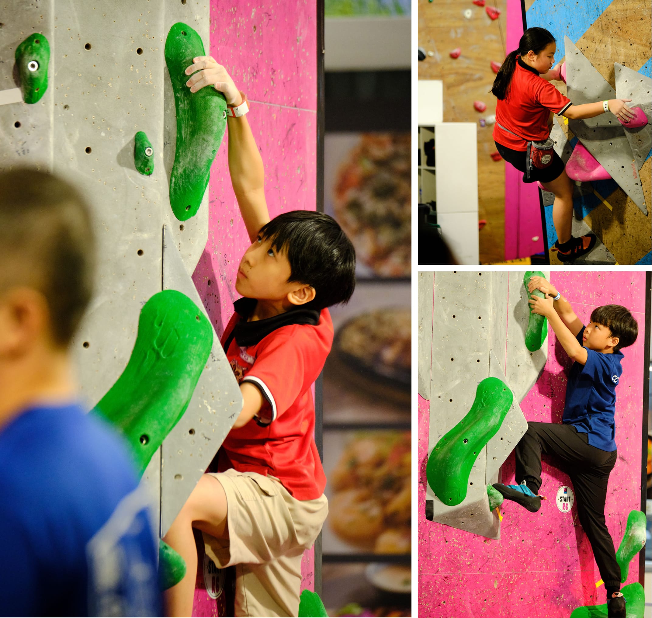 Three children climbing indoor bouldering walls with green and pink holds in a climbing gym.