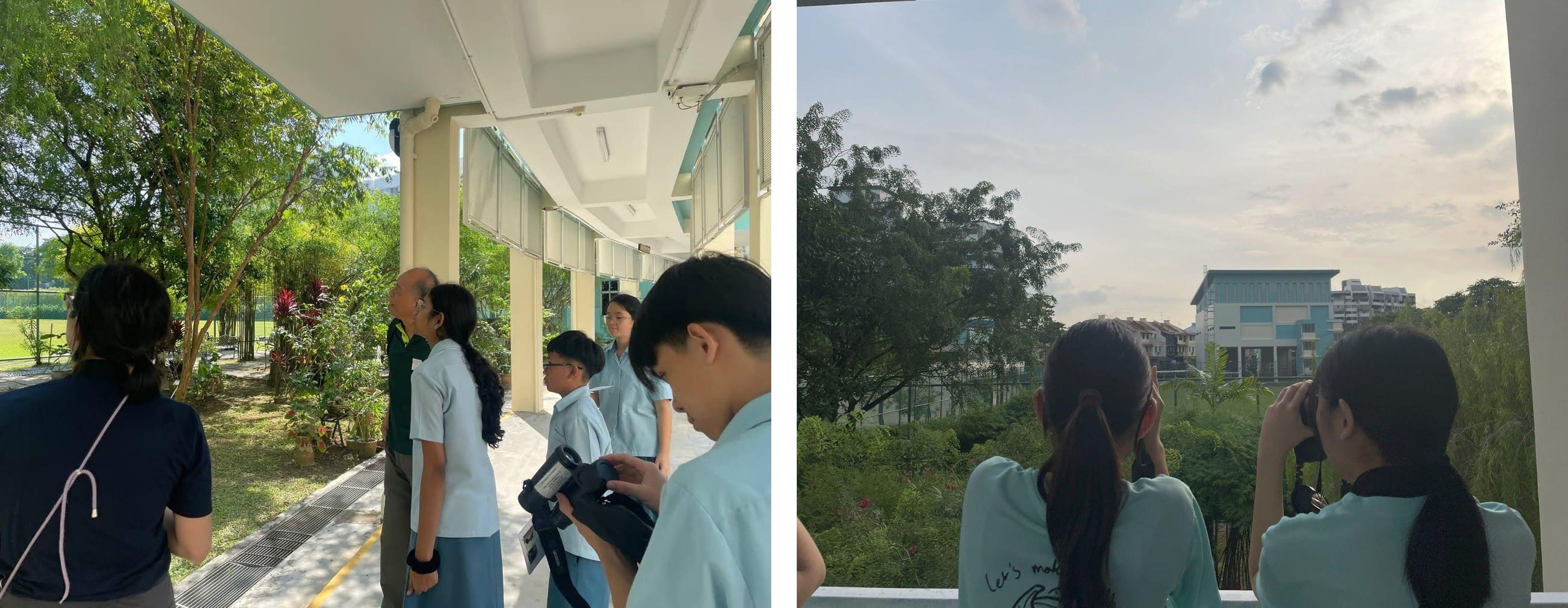 A split image shows students taking part in an outdoor learning activity. On the left, several students in school uniforms stand under a covered walkway, looking toward trees and plants while one holds binoculars. On the right, two students stand at a railing overlooking a green area, using binoculars to observe the surroundings. In the distance, a school building and residential blocks are visible under a bright sky.