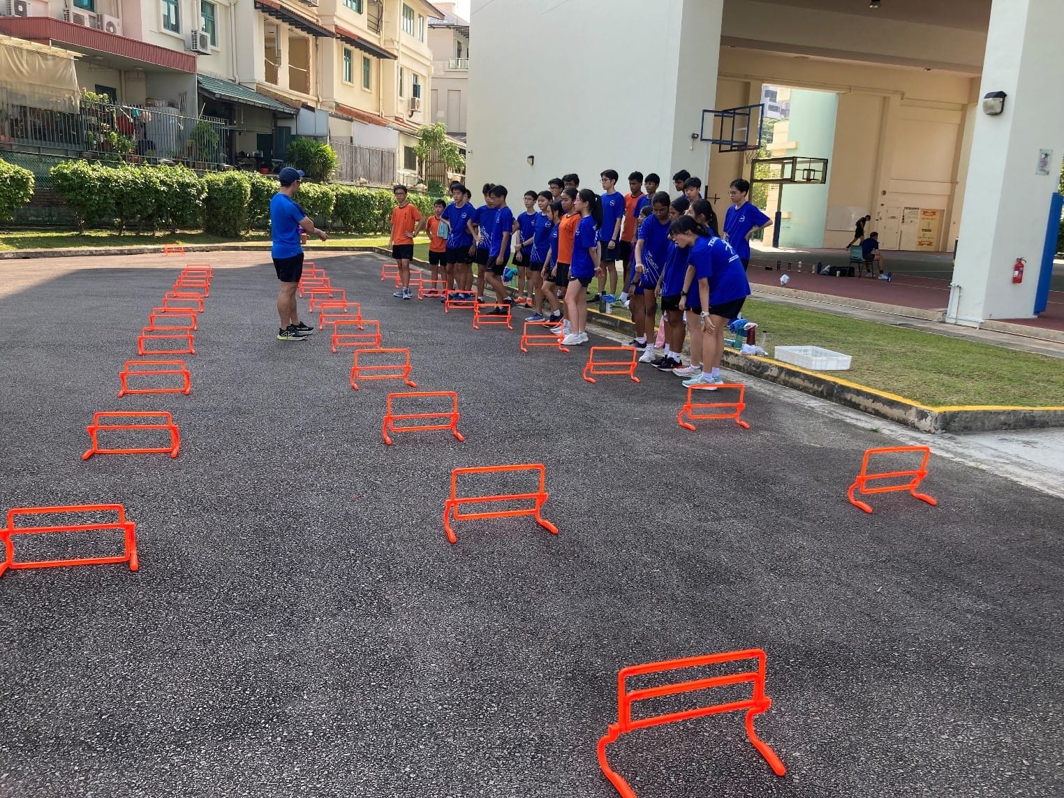 Students preparing for drills over the hoop.