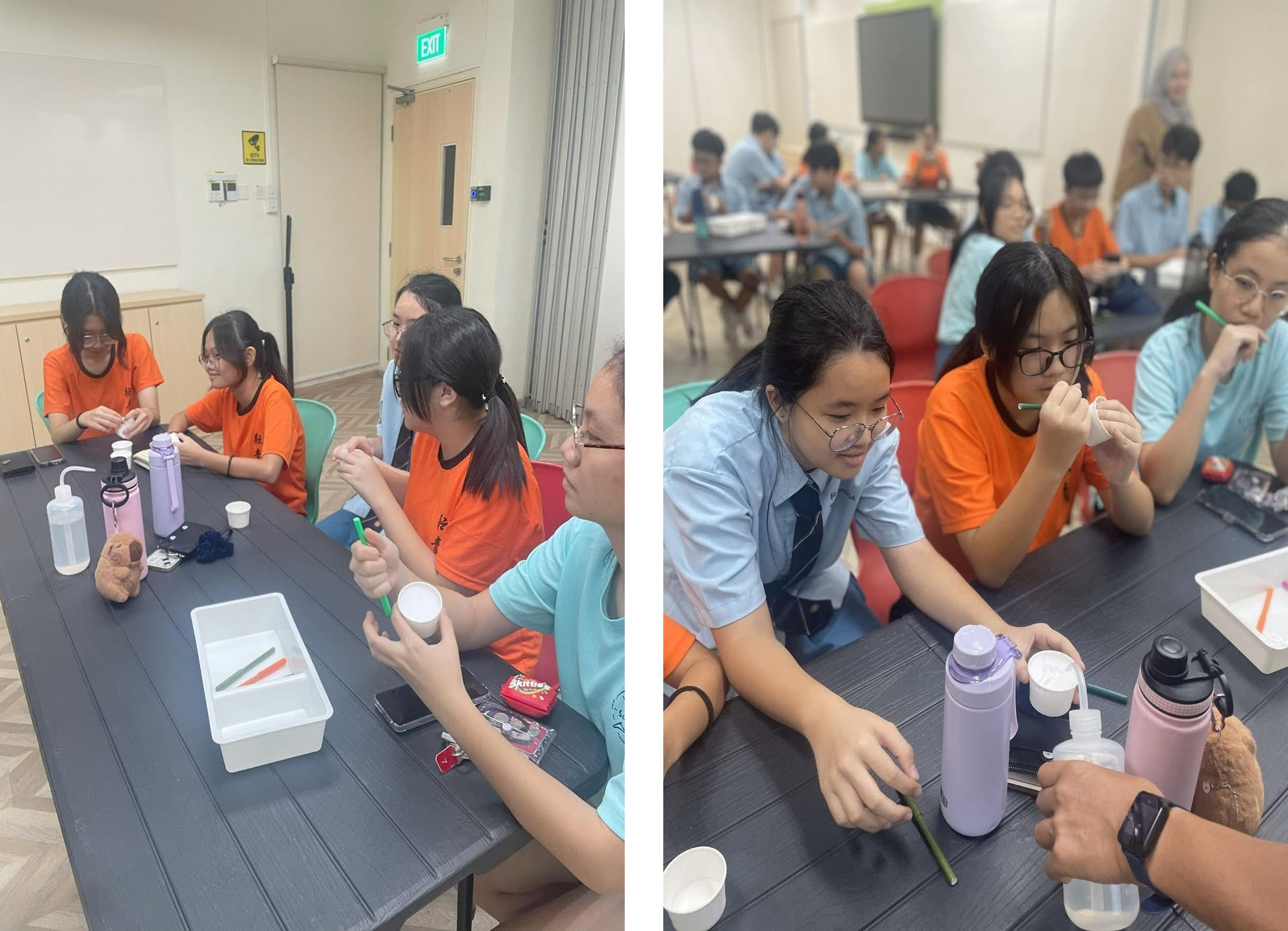 Two side-by-side views show students working together at classroom tables during a hands-on activity. In the foreground, several students sit around a dark table, holding small white cups, droppers, and pencils while carefully mixing or examining materials. In the background, more students sit in groups at other tables, focused on similar tasks.
