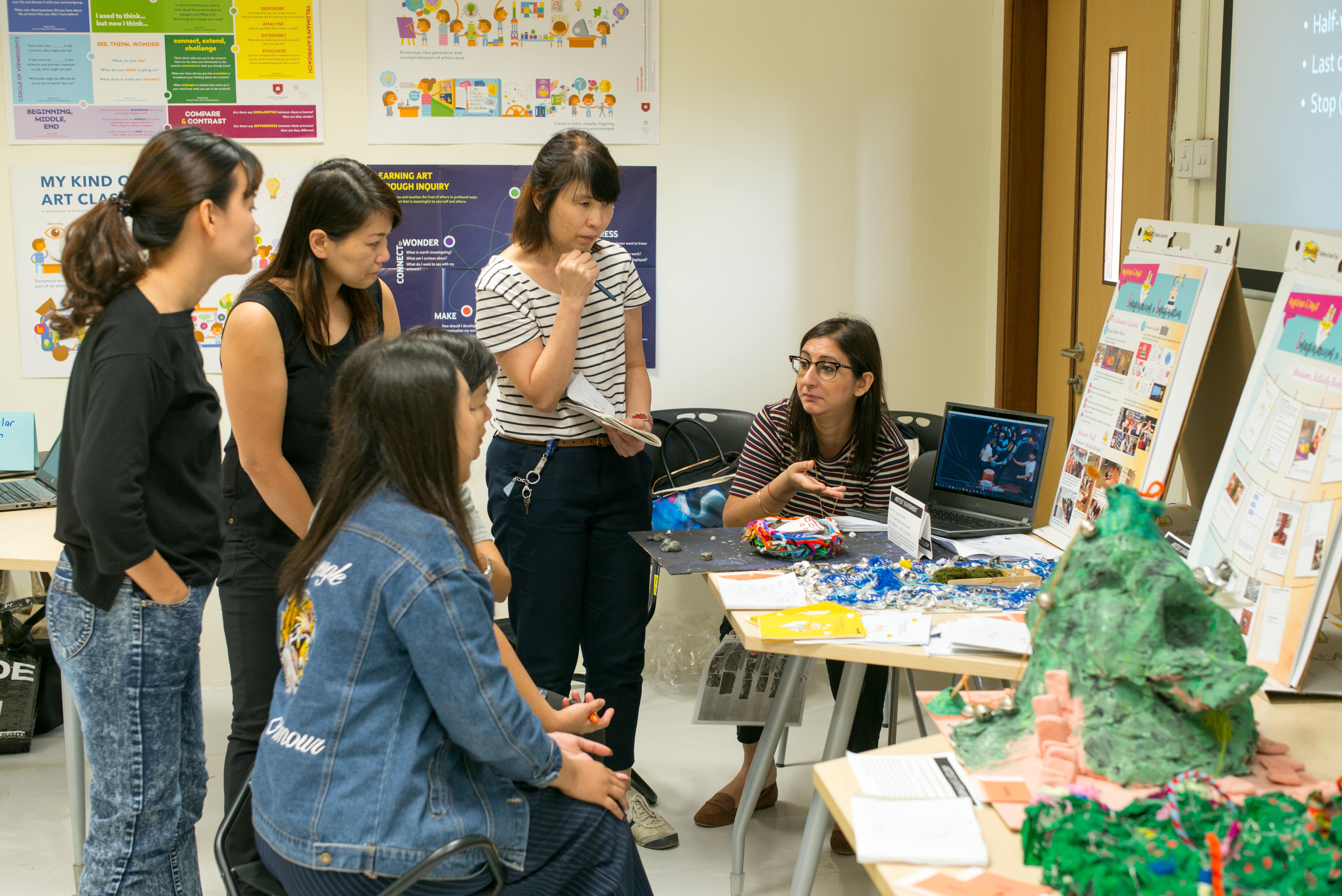 Art teachers in discussion as a colleague shares her ideas on inclusive art classrooms.