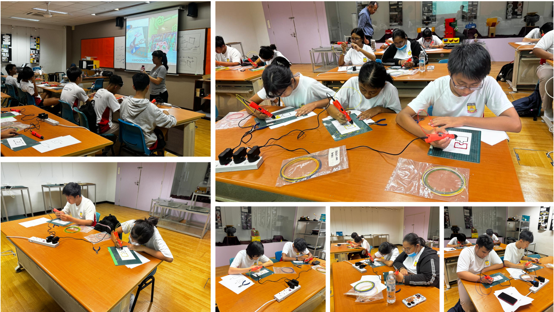 Students in white uniforms use red 3D pens at wooden desks in a classroom with a projected presentation.