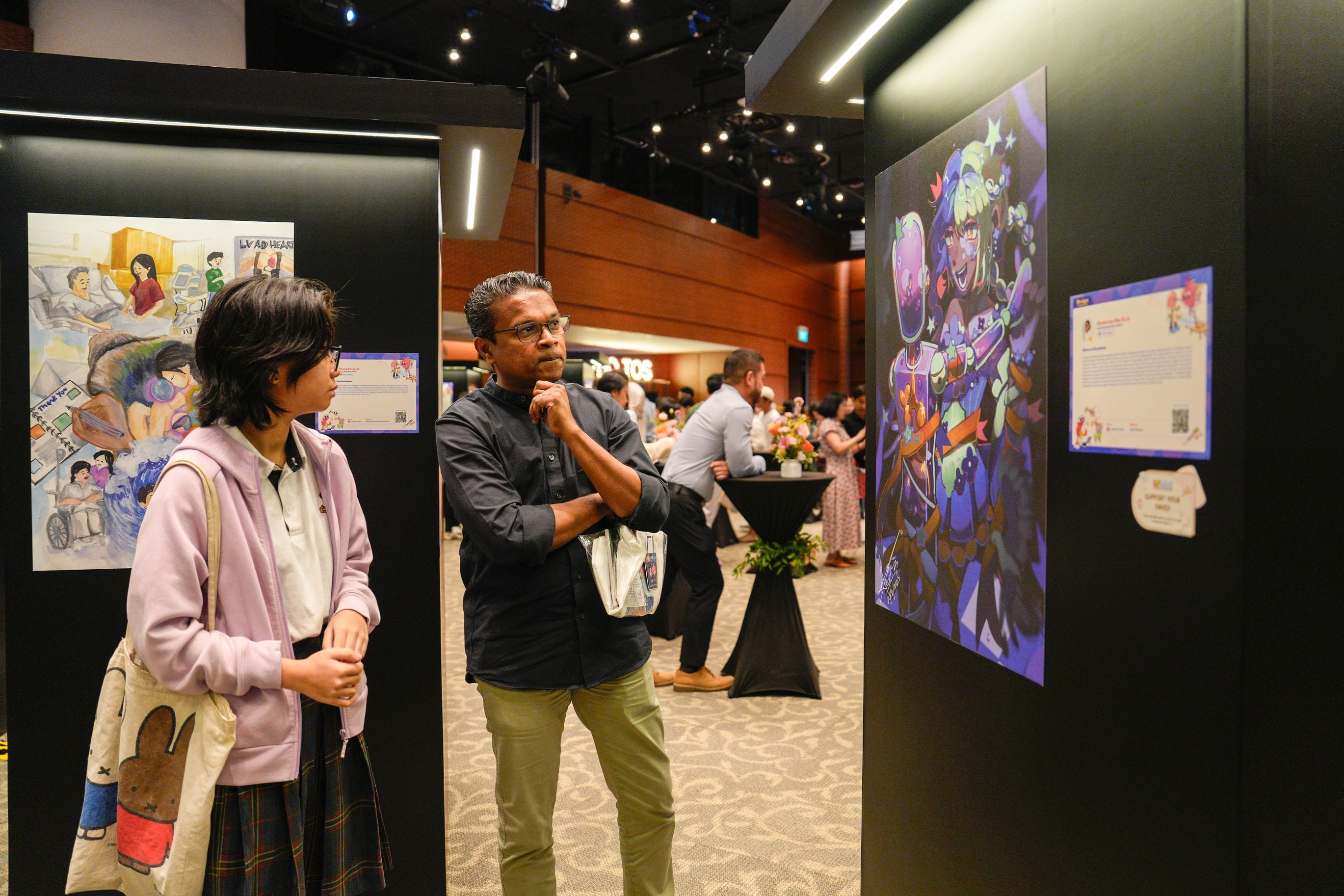 A member of public looking at a winning artwork in deep thought