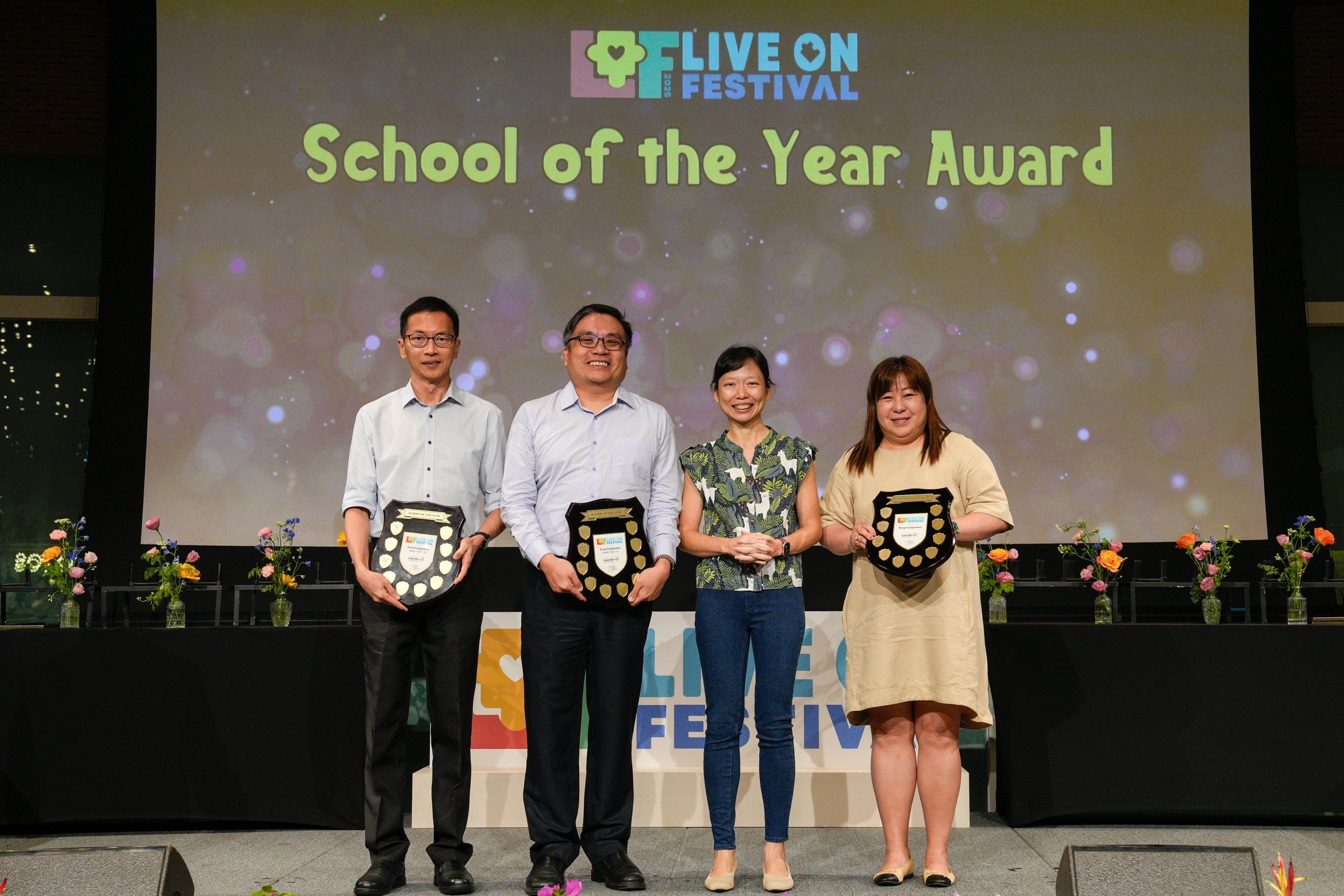 Representatives for the School of the Year Award posing for a photograph beside the guest-of-honour