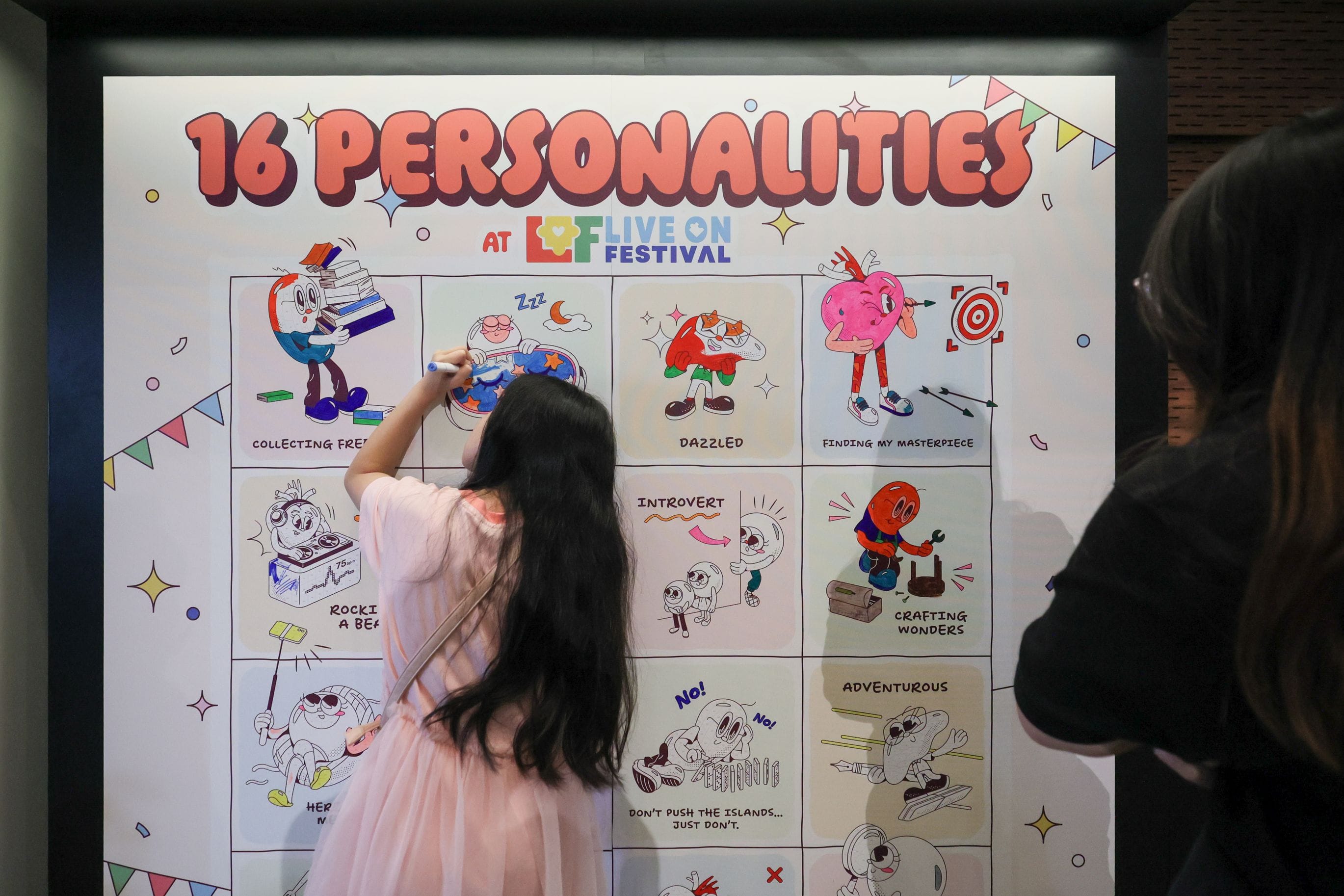 A member of public coloring a segment of the "Paint by Numbers" activity