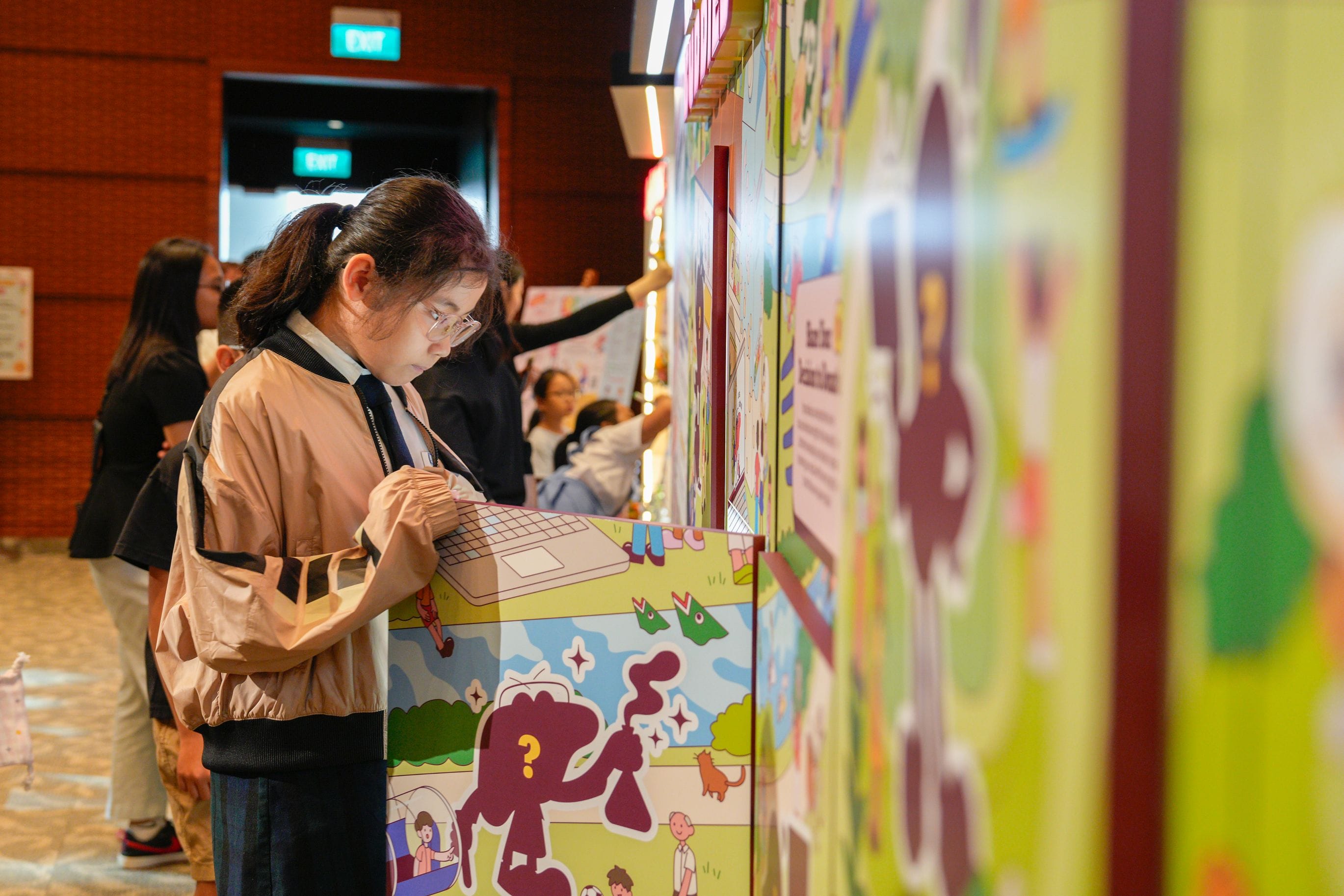 A student looking at the contents within a window of the Live On Buddies display