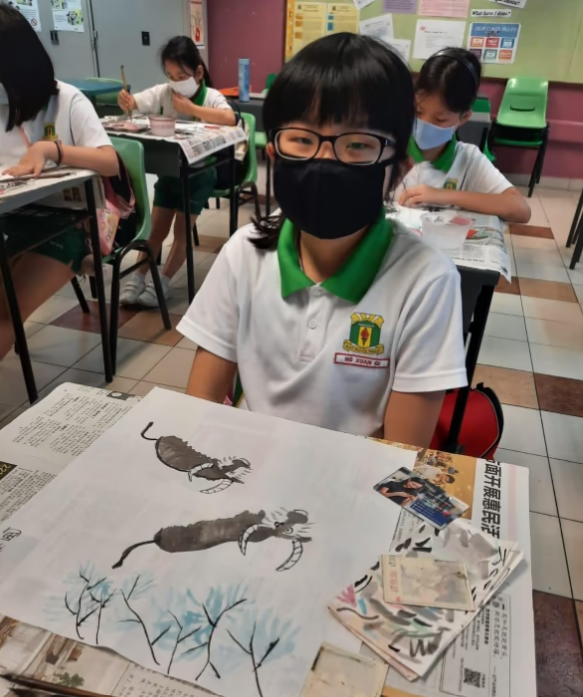 student displaying calligraphy