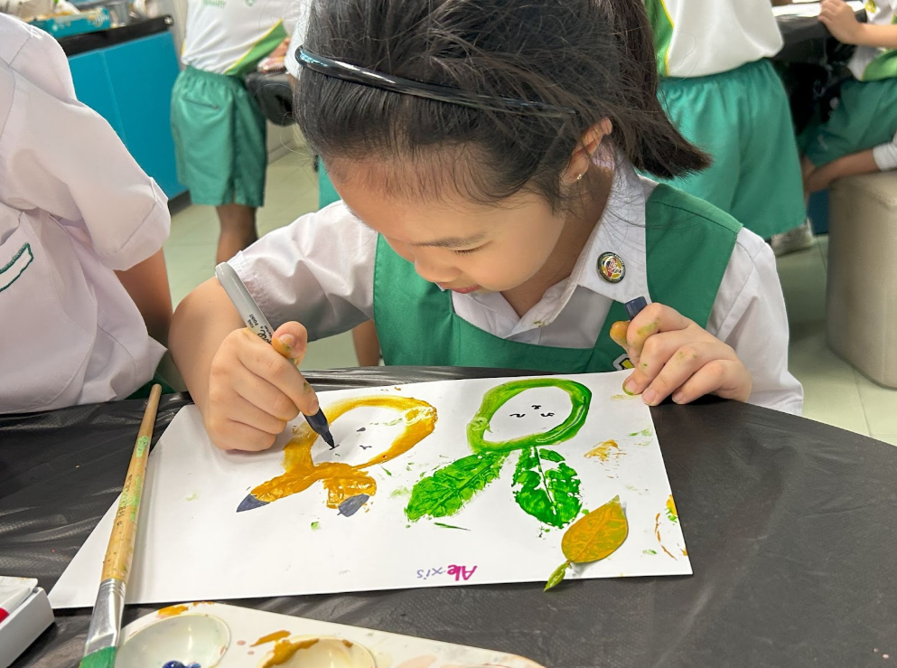 student drawing using a marker of a vegetable