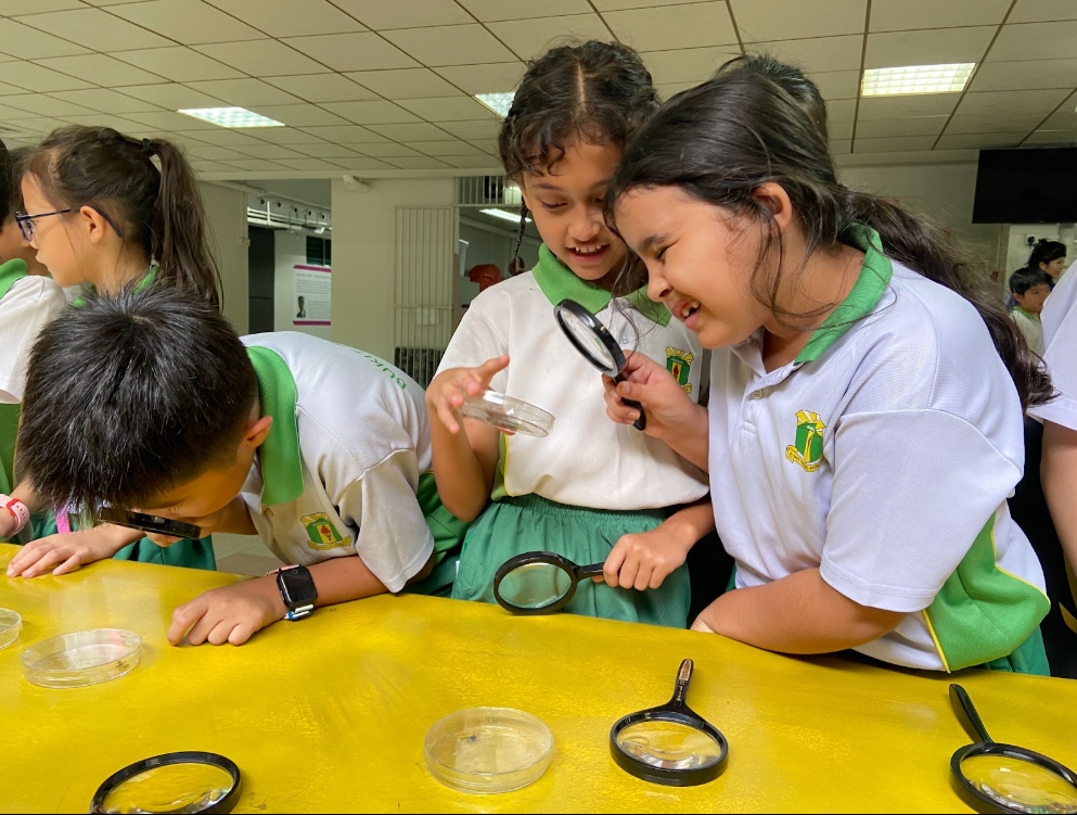 A student looking though a magnifying glass