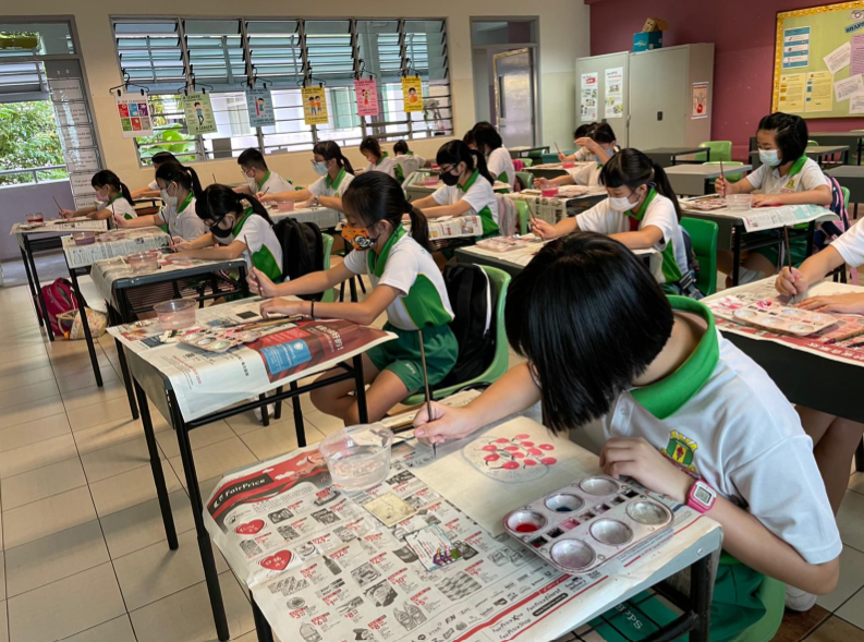 student working on their calligraphy