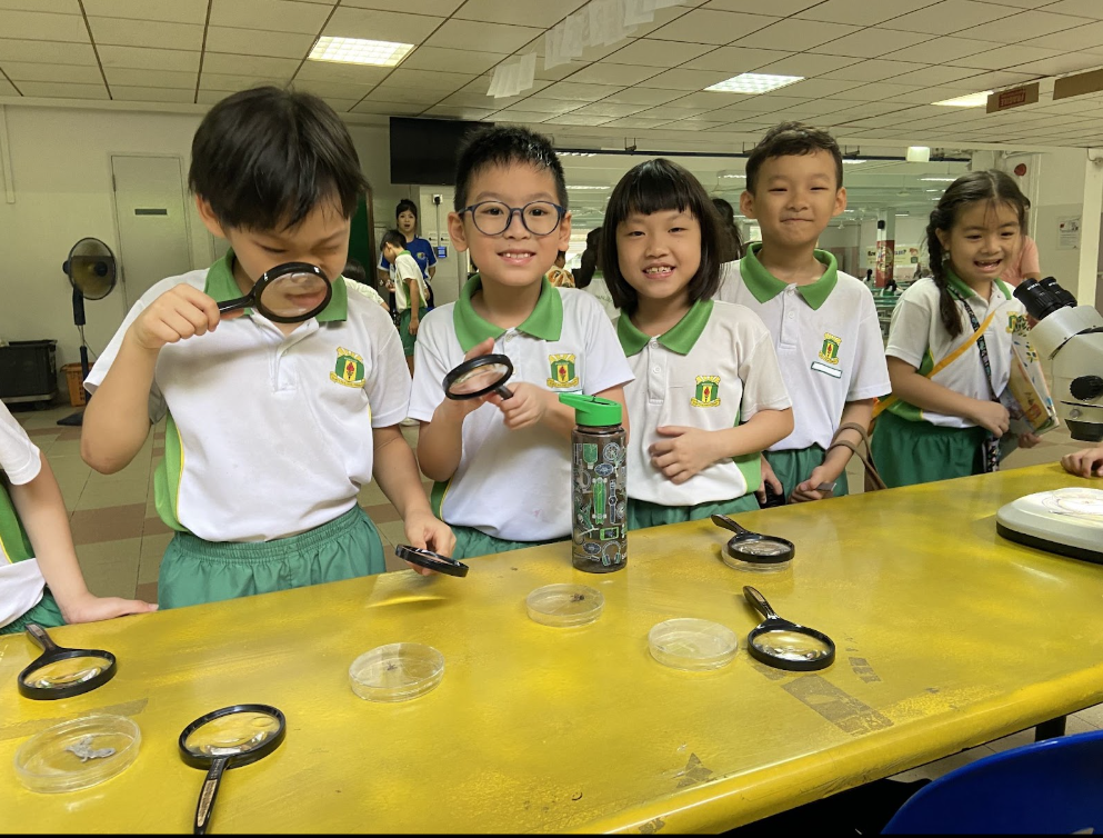 A group of student posing with their magnifying glass