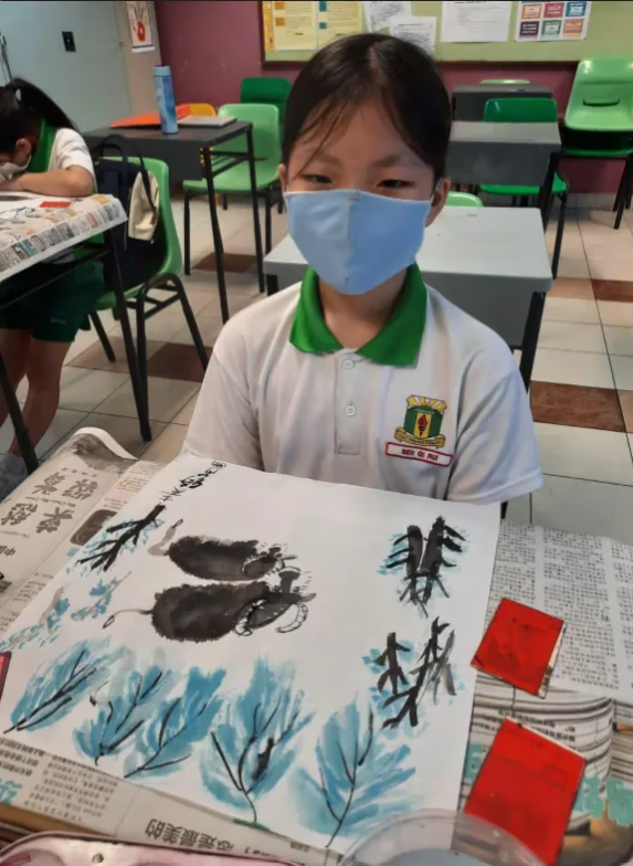 student displaying calligraphy