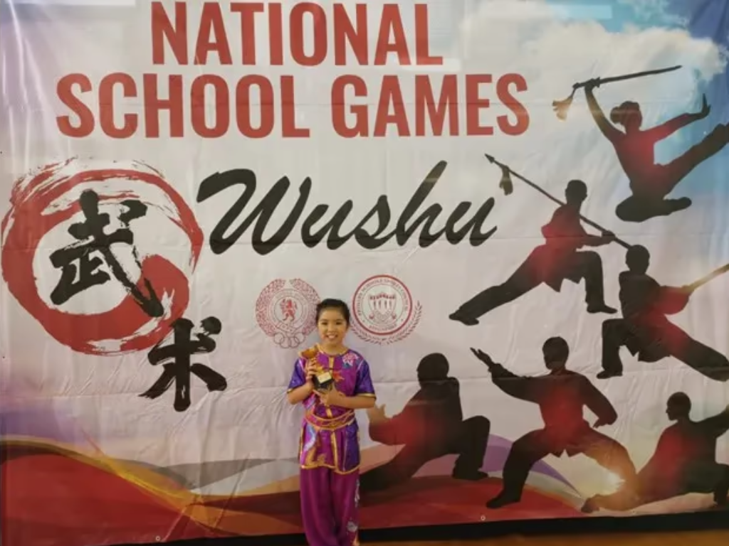 Wushu girl poses with award