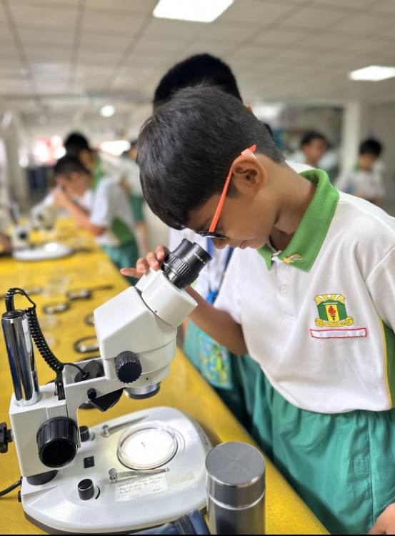 A student looking through a microscope
