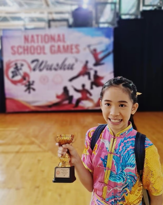 Girl receiving a award poses