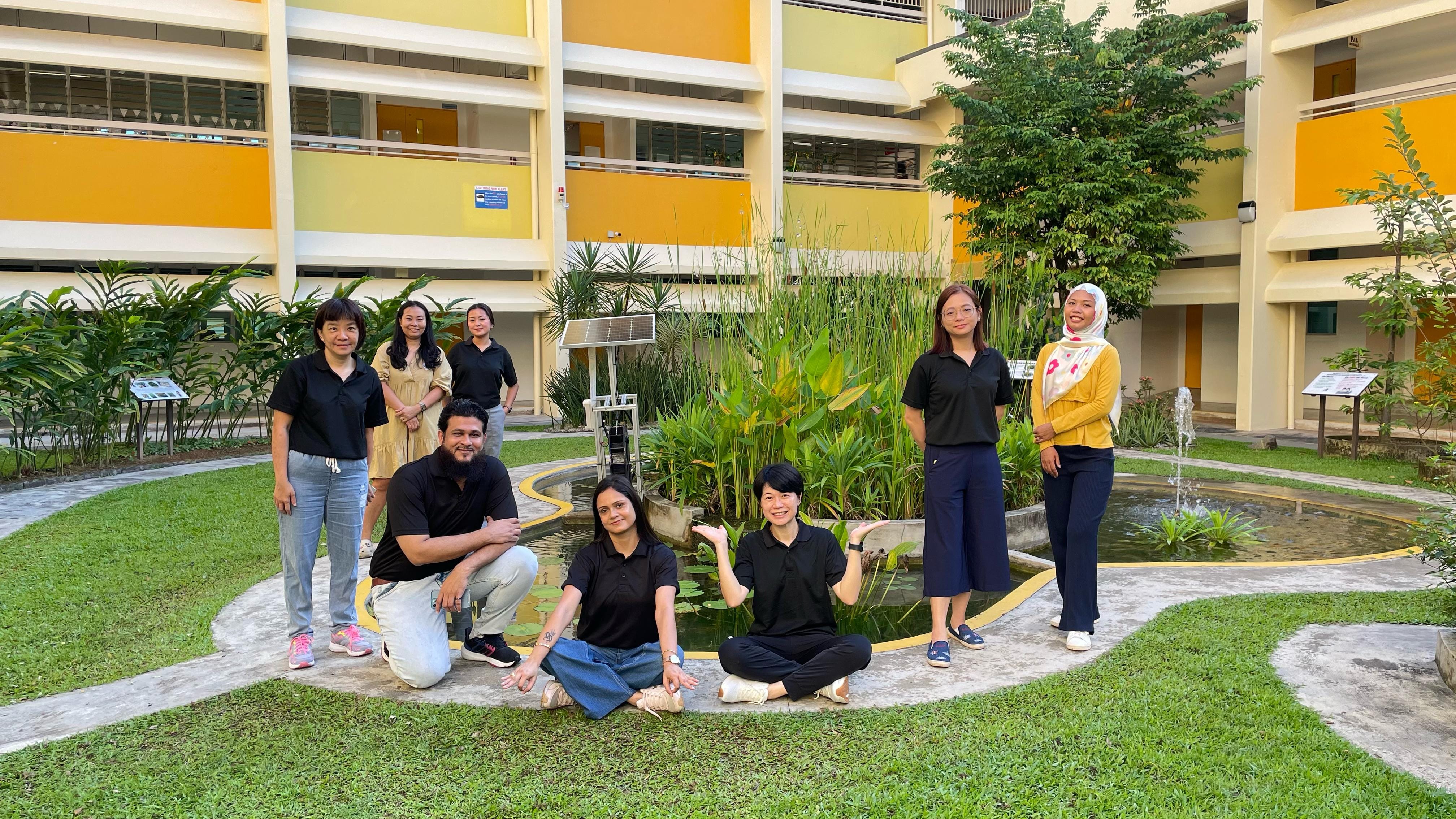 Members of the Fuchun Primary School Parents Support Group posing for a group photo in the school eco-garden.