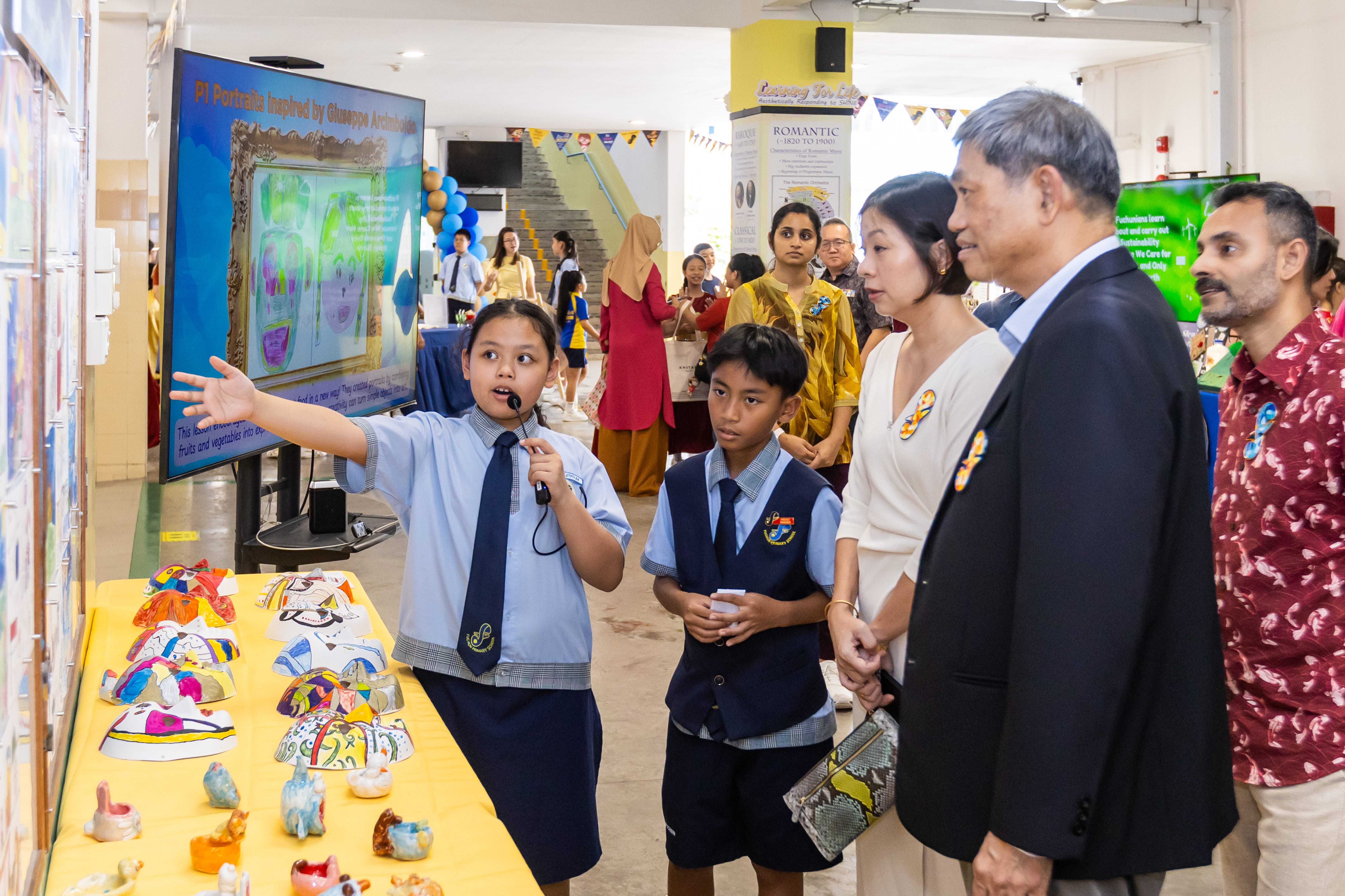 Students sharing their project work with guests.