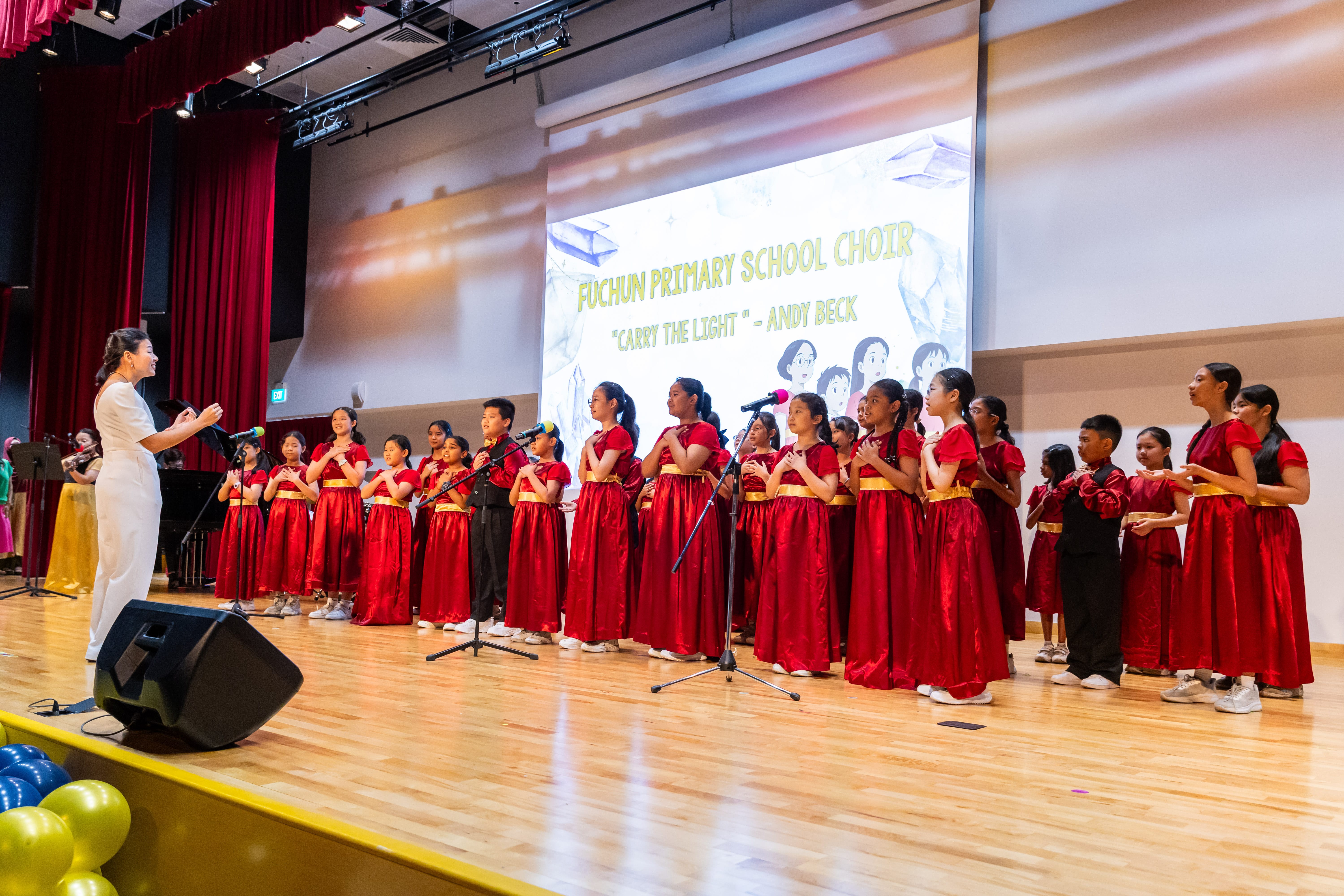 Fuchun Primary School choir performing on stage during Arts Fiesta.