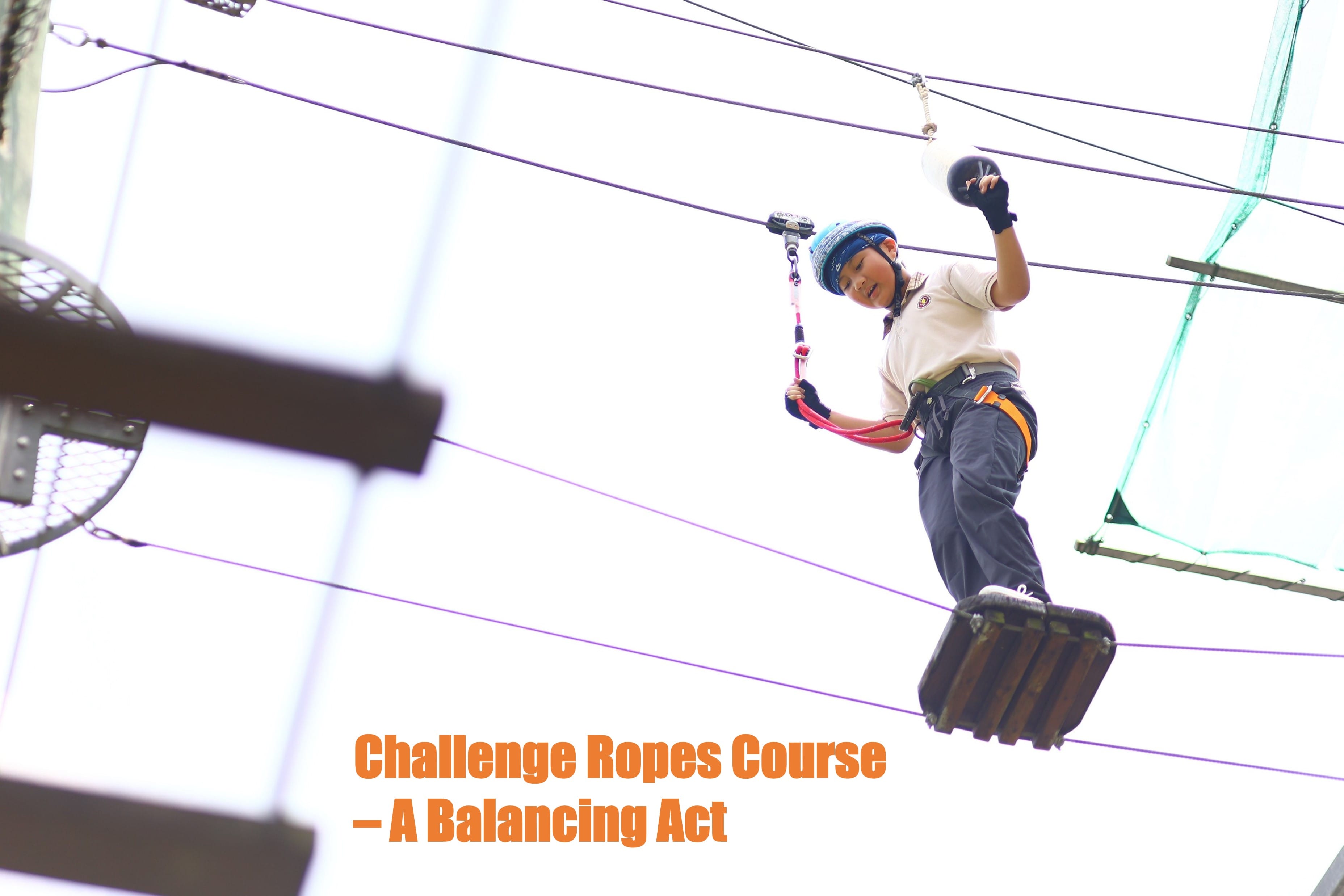 A balancing acting by a P5 student on the challenge ropes course