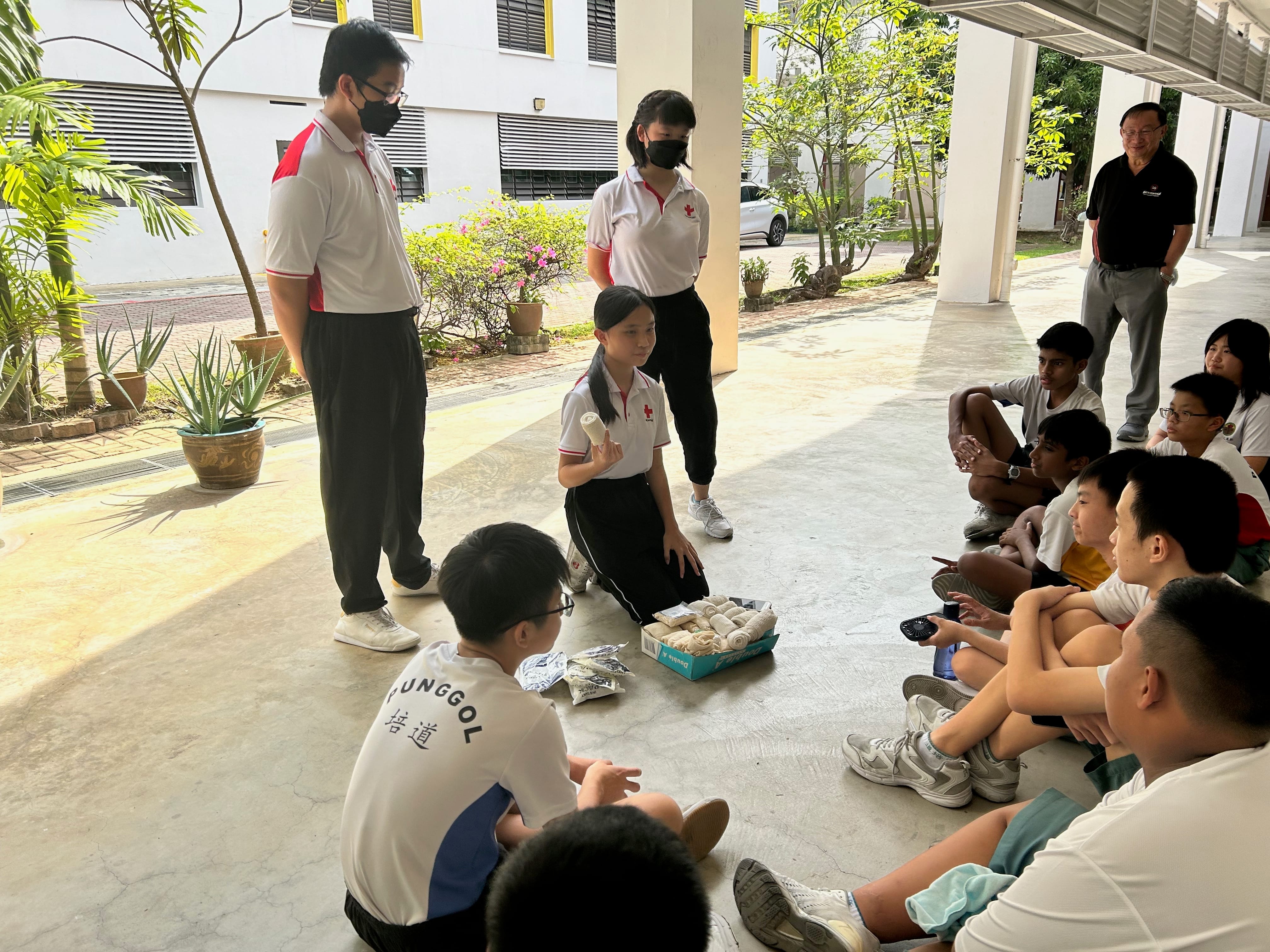 Red Cross cadets volunteering at a community service event or blood donation drive