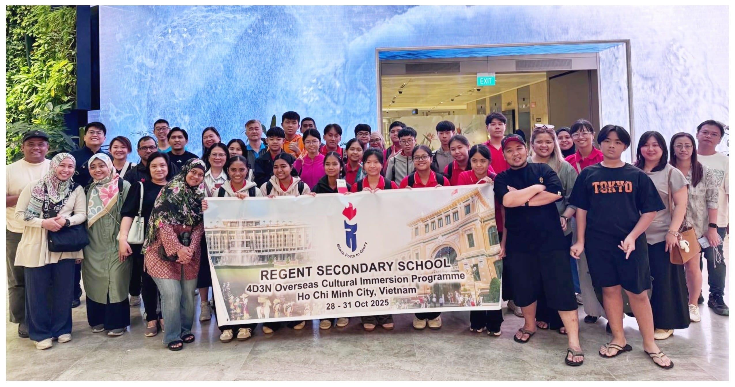 Large group posing with a Regent Secondary School banner for a Ho Chi Minh City cultural immersion trip, Oct 2025.
