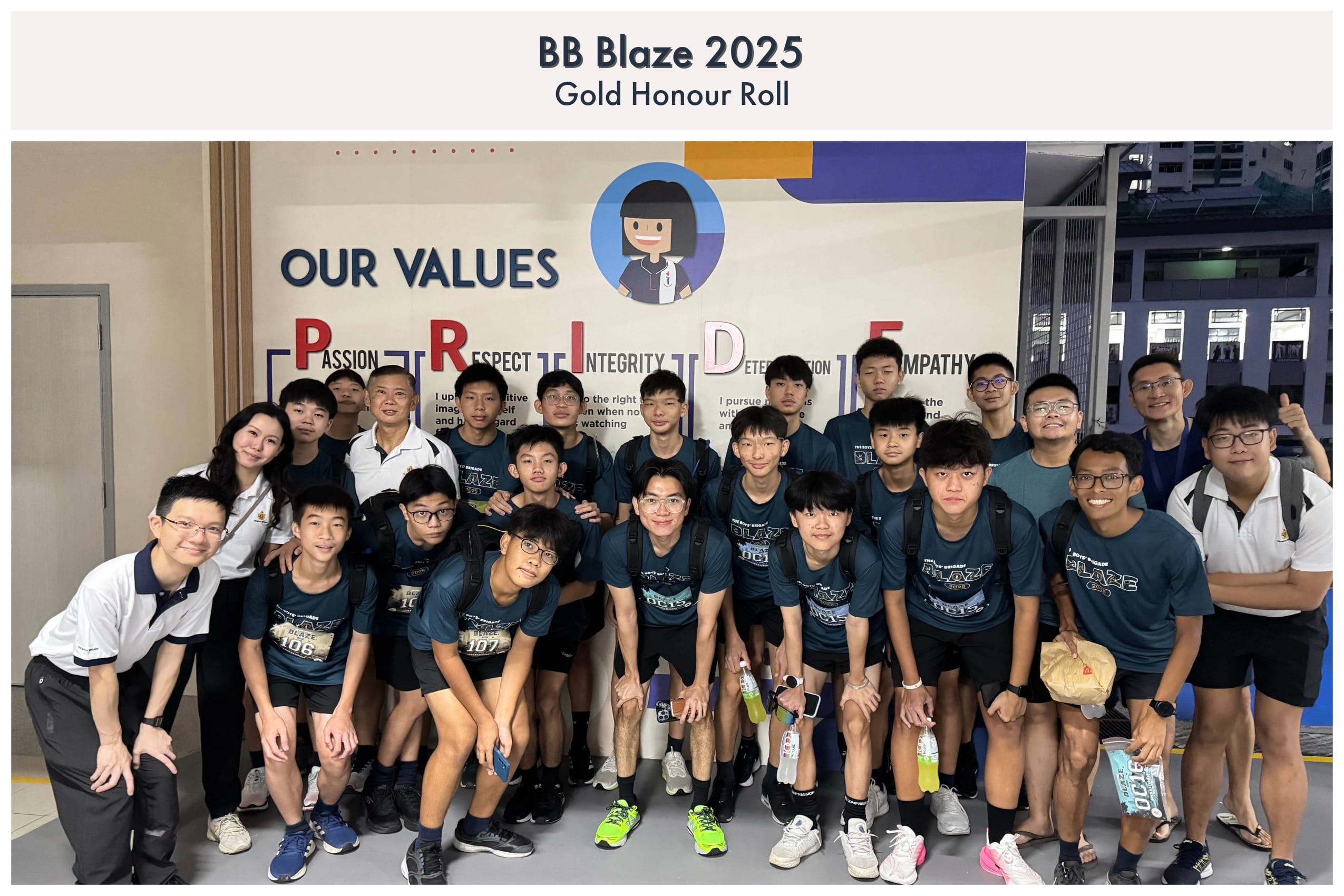 Group of students and teachers posing in front of an "Our Values PRIDE" wall mural for BB Blaze 2025 Gold Honour Roll.
