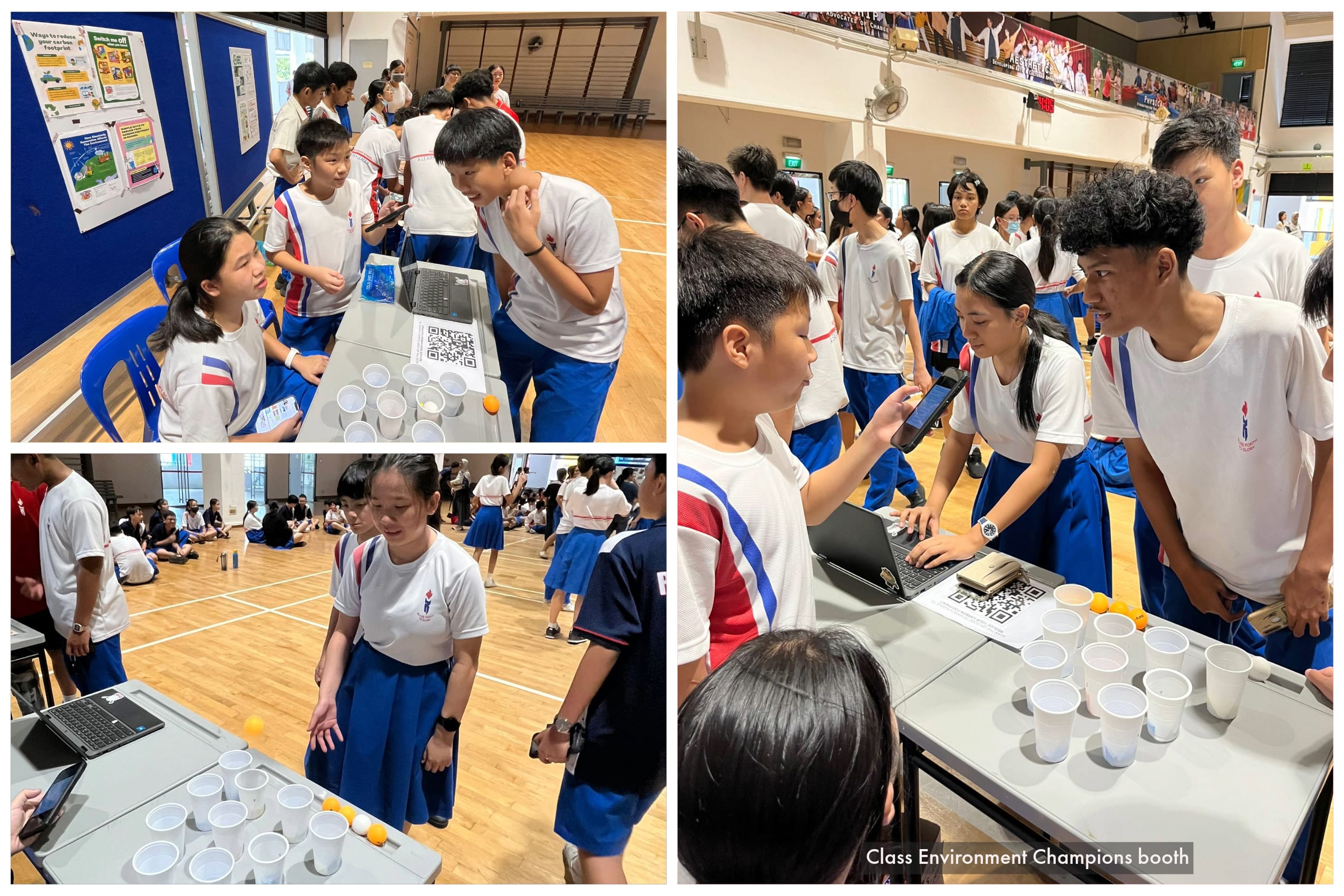 Students in white uniforms gather at a gym booth table with cups, ping-pong balls, laptop, and QR code.