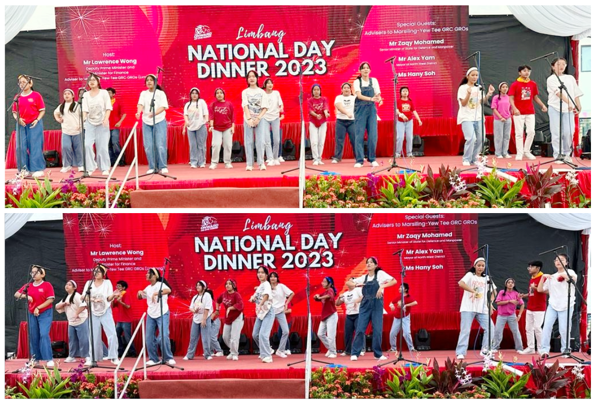 Young performers singing and dancing on a red stage at the Limbang National Day Dinner 2023 event.