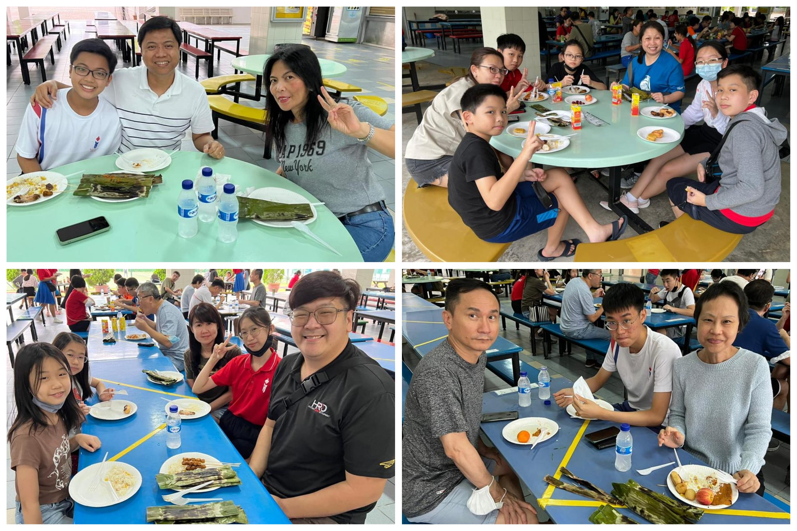 Four groups of families eating meals together at an open-air hawker centre with food on plates and water bottles.