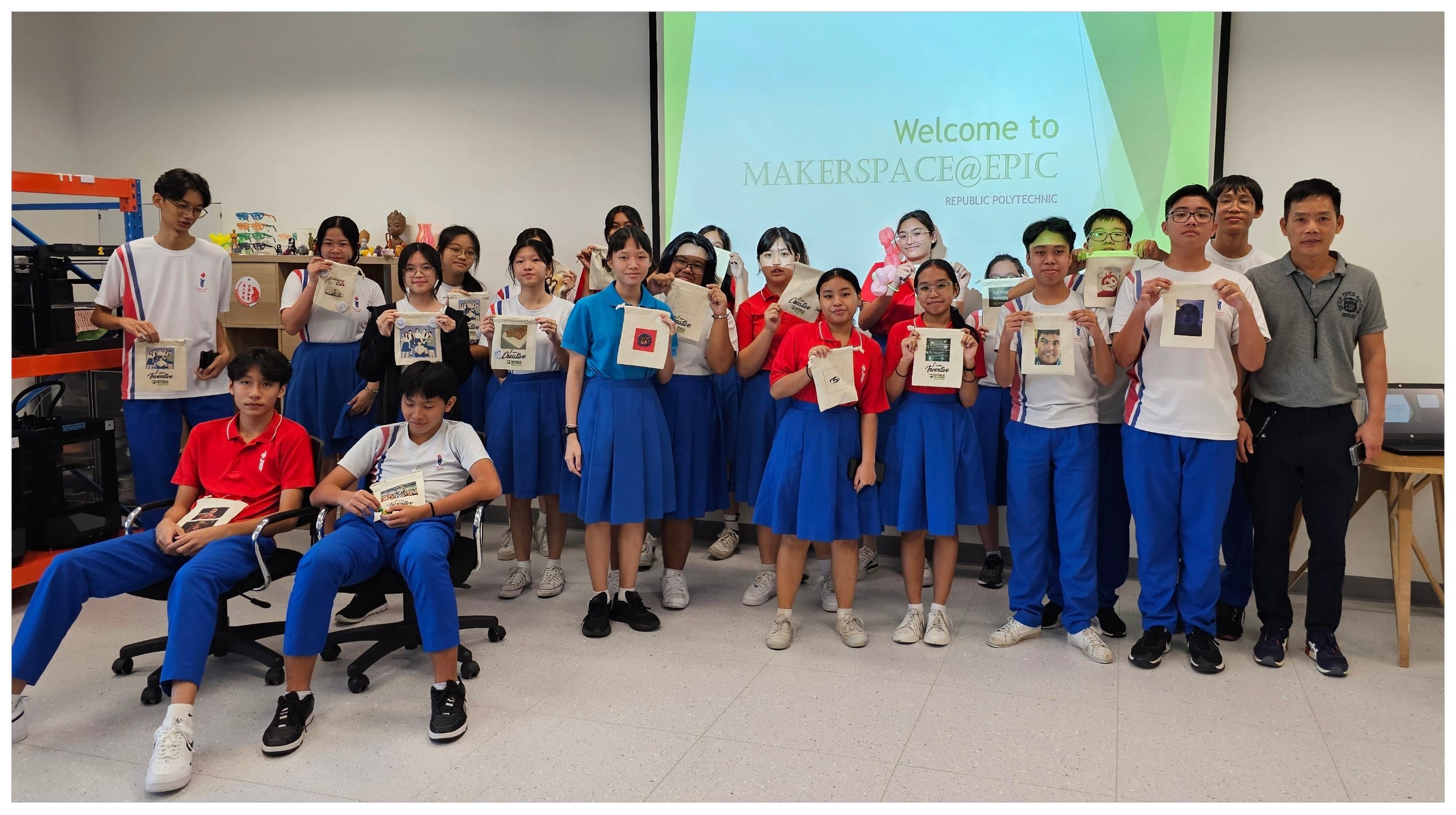 Students in blue uniforms hold printed tote bags at Makerspace at EPIC, Republic Polytechnic.